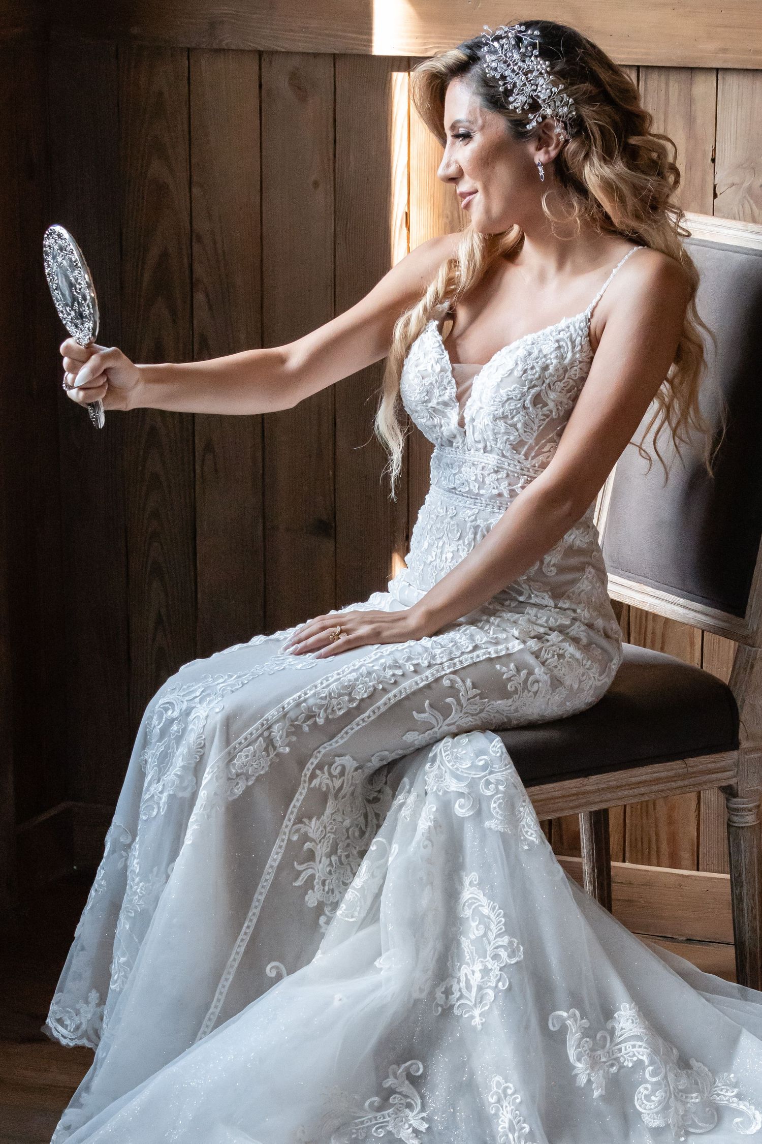 Detailed shots of lace wedding dress and crystal hair accessories in rustic barn setting.