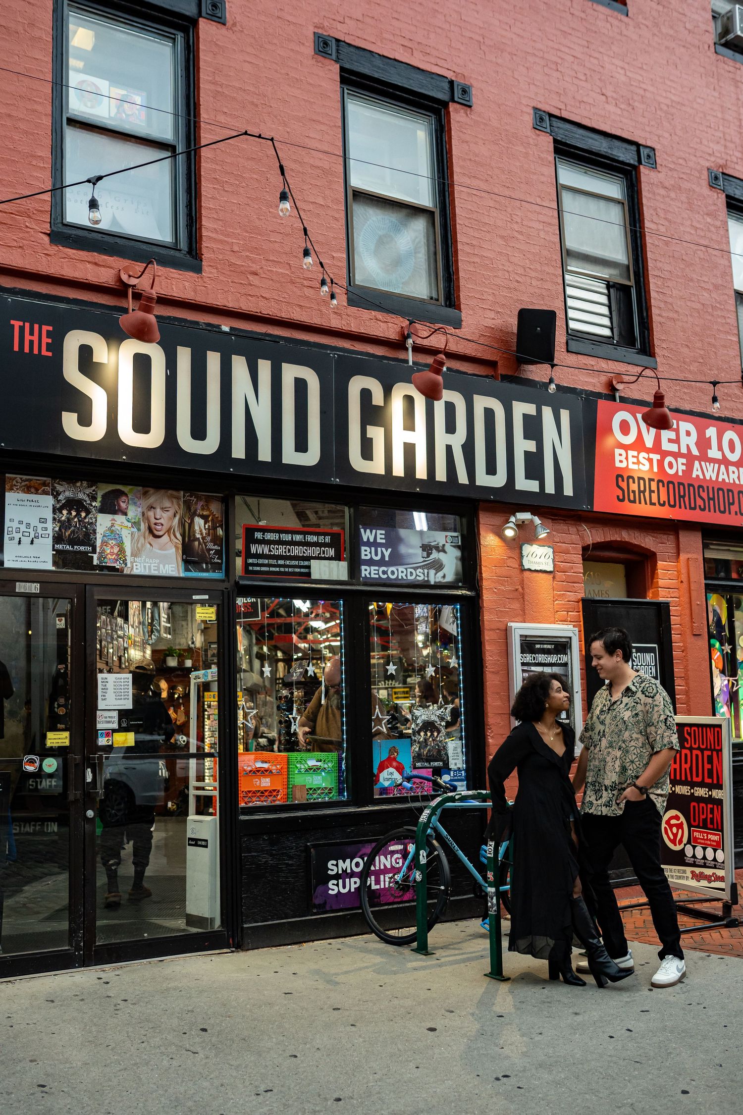 Street view of The Sound Garden store with large signage on brick building.