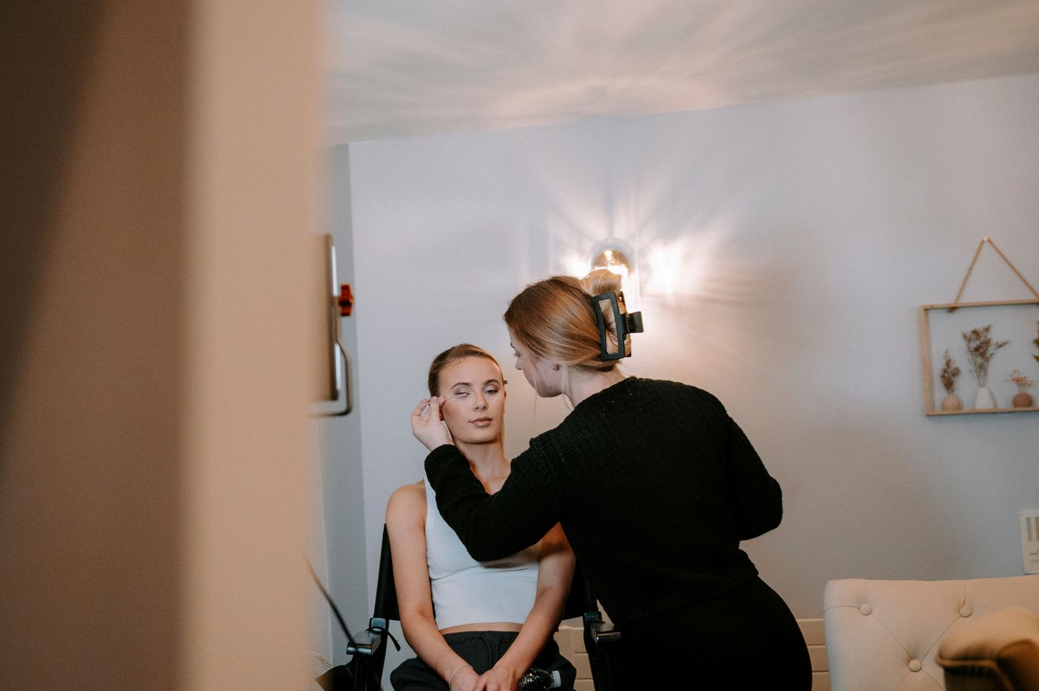 Professional beauty preparation session in a bright, modern studio setting.