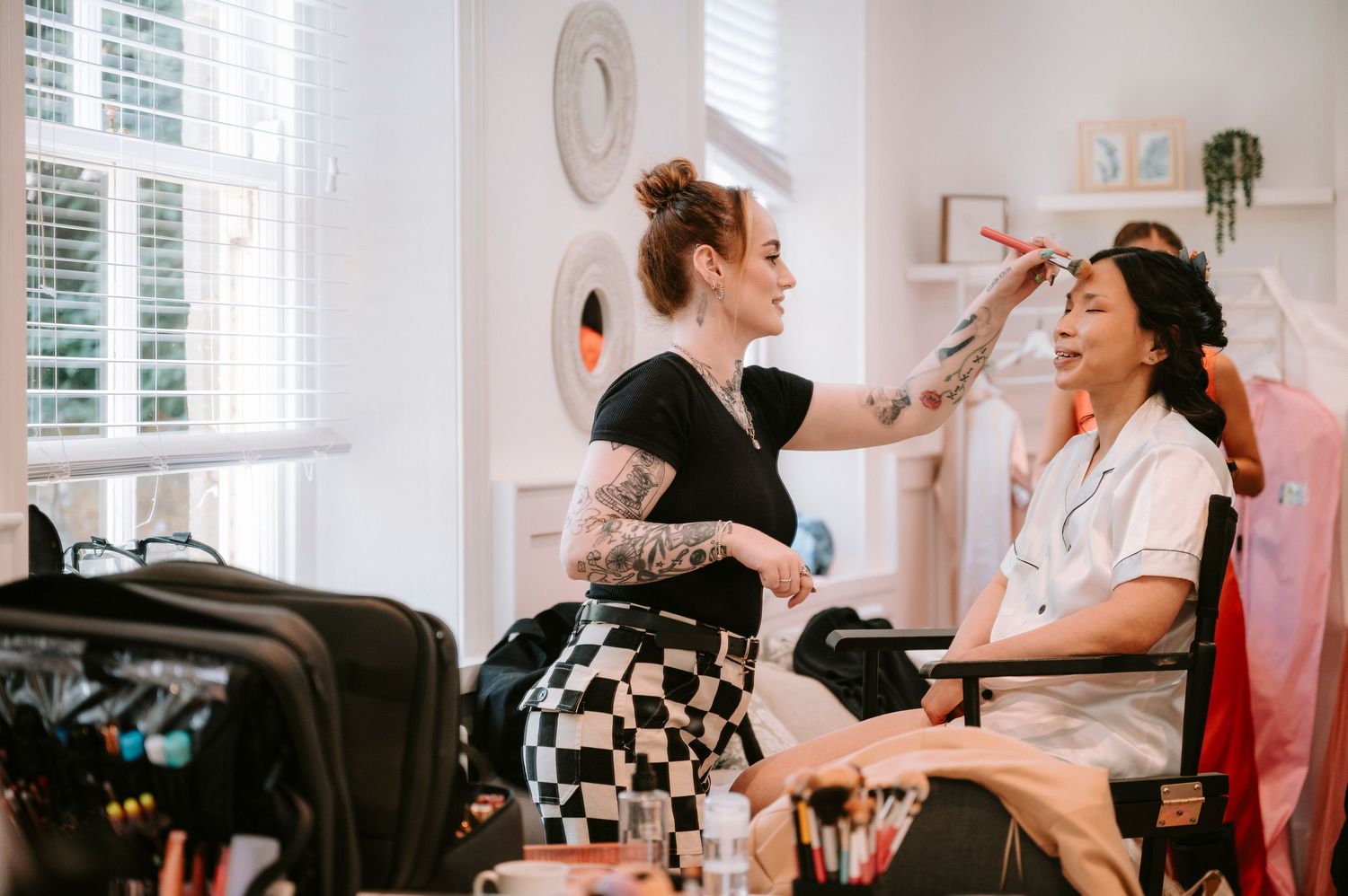 Wedding preparation scene in bright white room with checkered details.