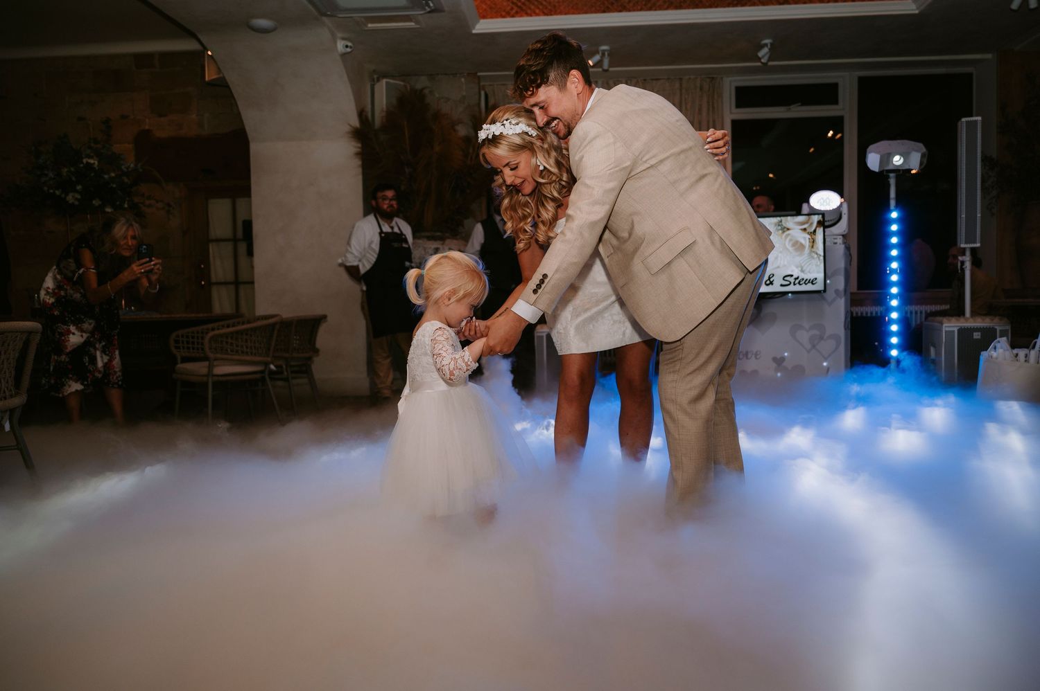 Wedding dance floor with atmospheric fog and blue lighting creating a dreamy ambiance.