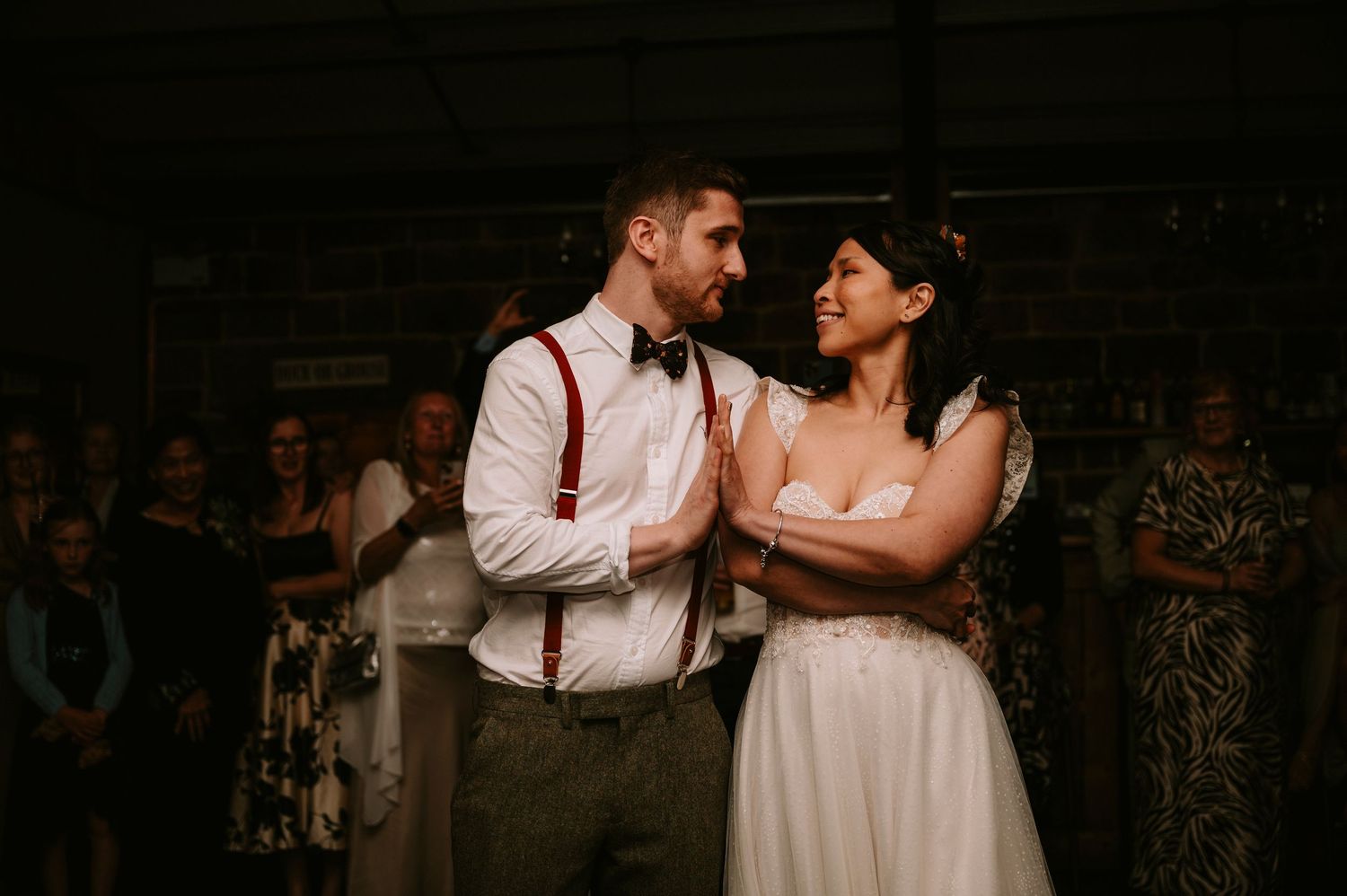 Wedding couple dances together during their first dance at an intimate reception venue.