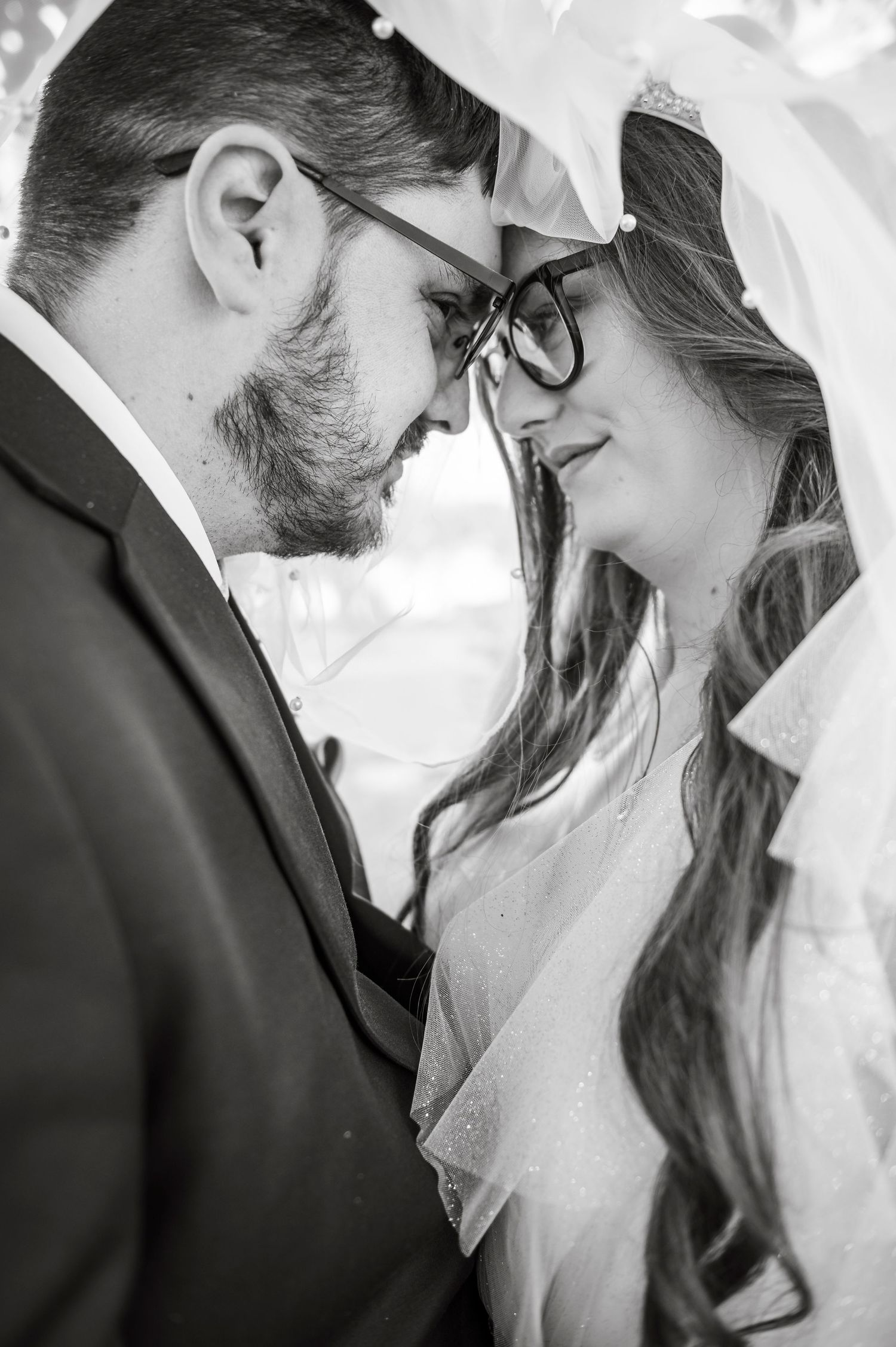 Black and white intimate wedding portraits showing tender moments between newlyweds.