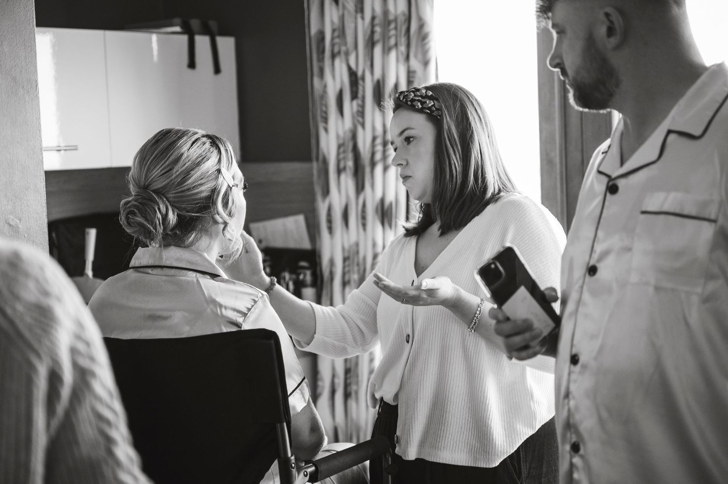 Behind the scenes moment of wedding preparations in black and white.