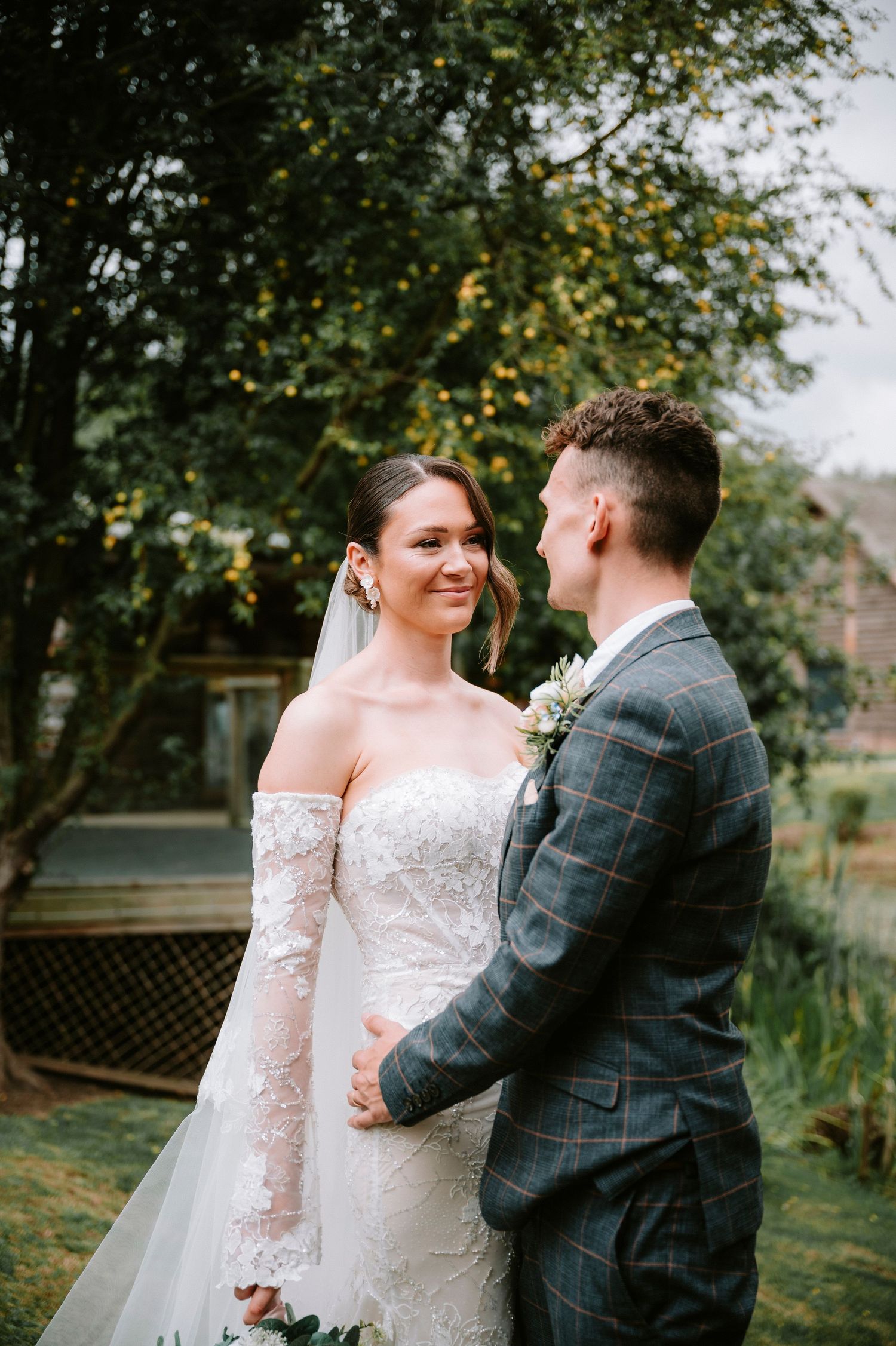 Romantic outdoor wedding portraits with couple in autumn garden setting.