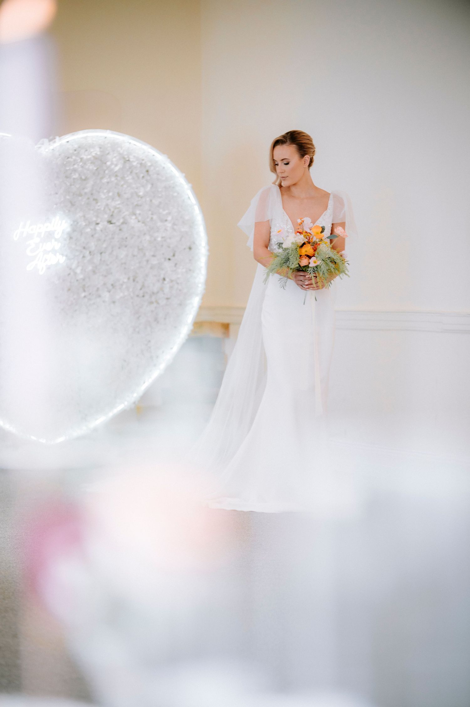 Ethereal bridal portraits with soft lighting and dreamy bokeh effects showcase a white wedding gown and floral bouquet.