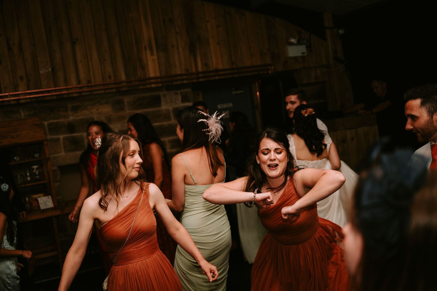 Guests dancing and celebrating at lively wedding reception.