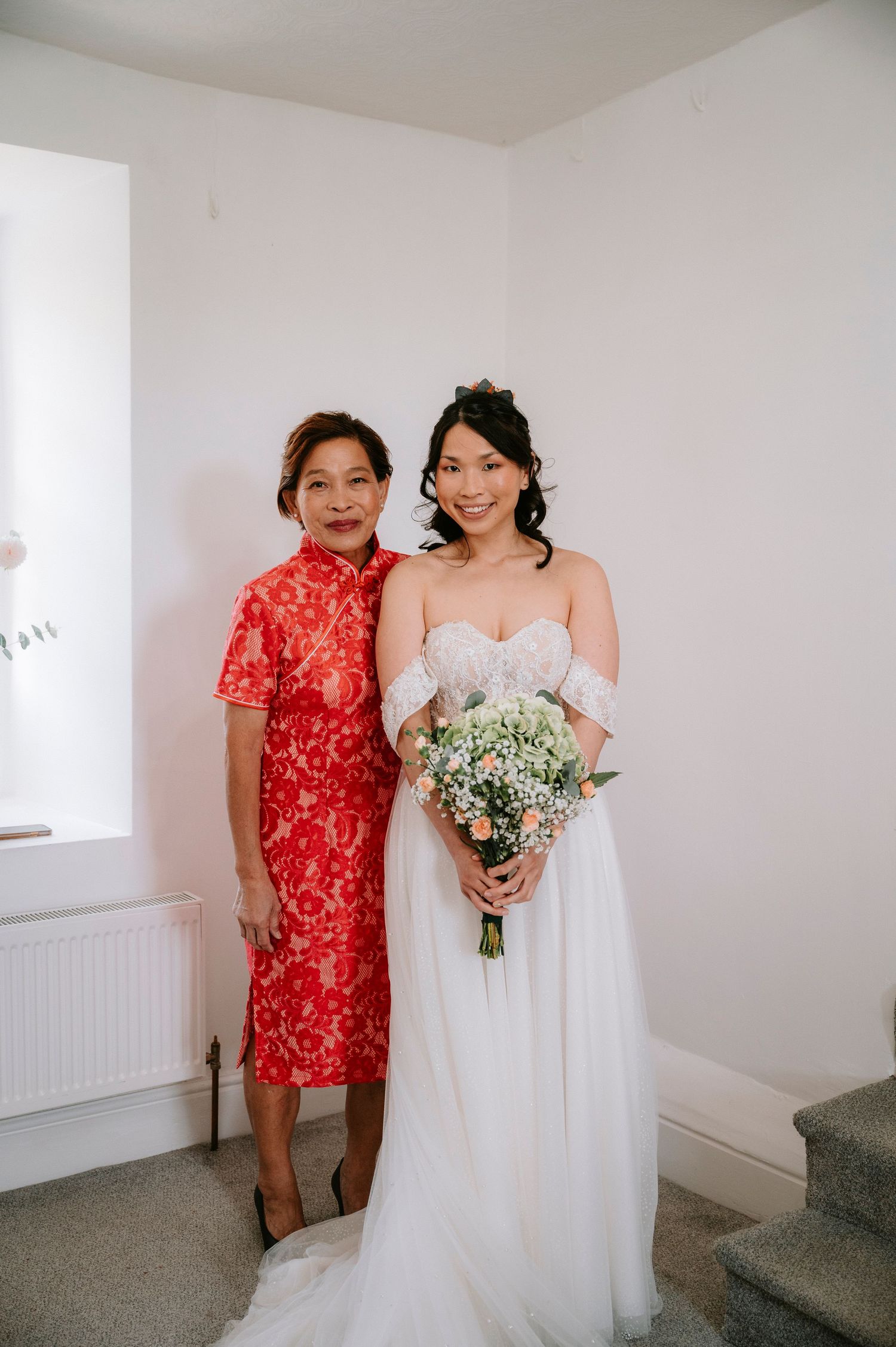 Traditional Chinese qipao dress in red silk worn during wedding preparations.