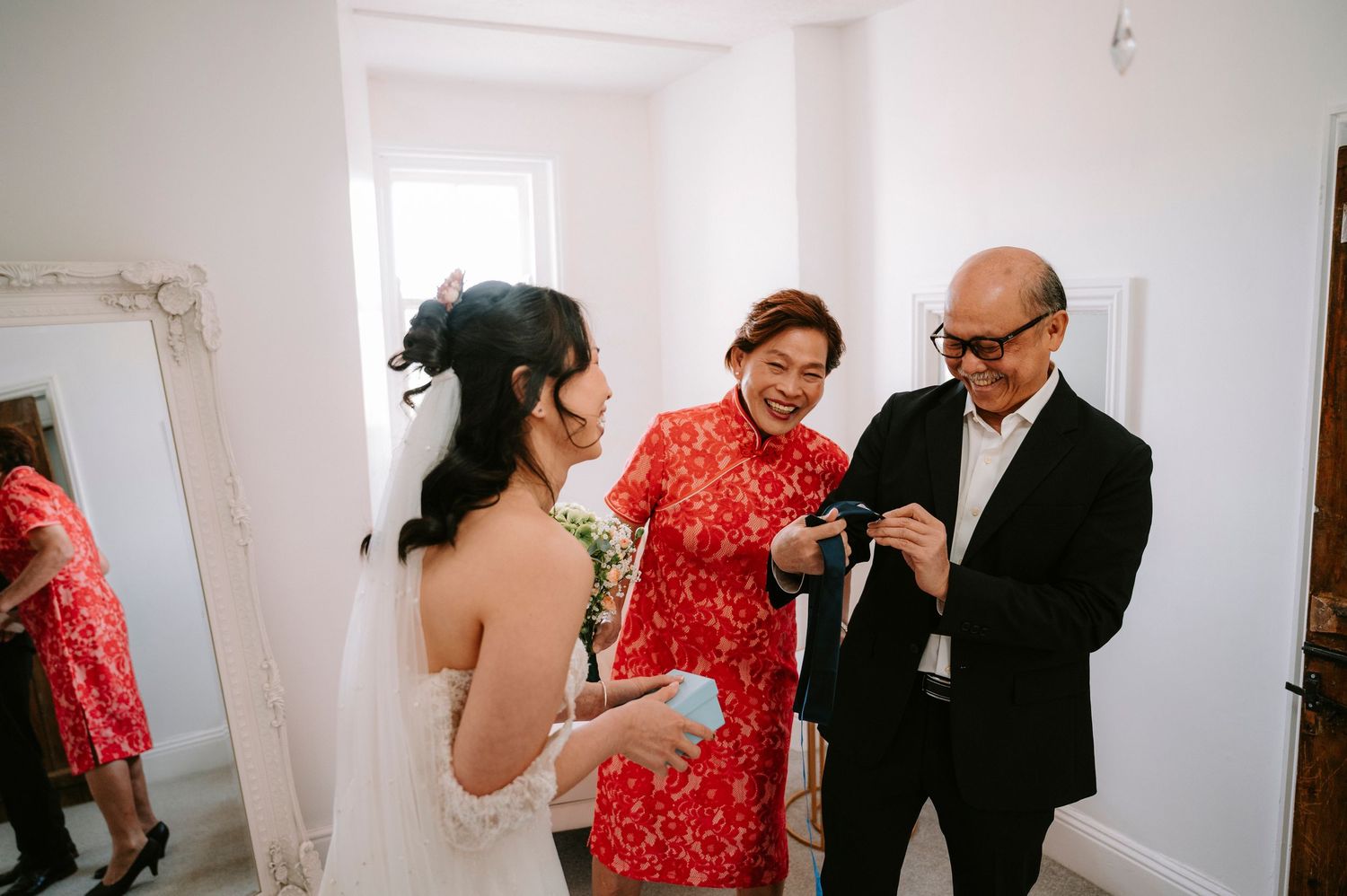 Wedding day preparations in a bright white room with natural lighting.
