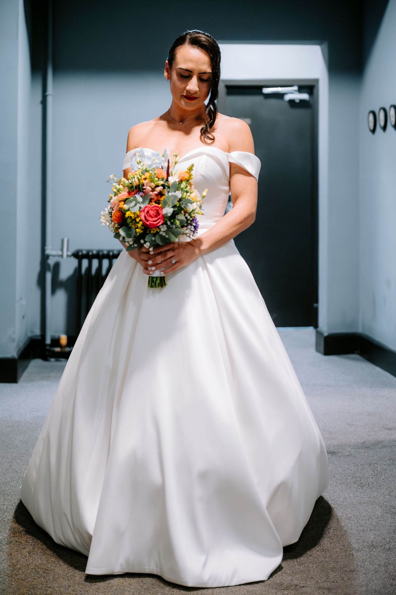 Artistic shots of a bride in a classic white ball gown holding a vibrant floral bouquet.