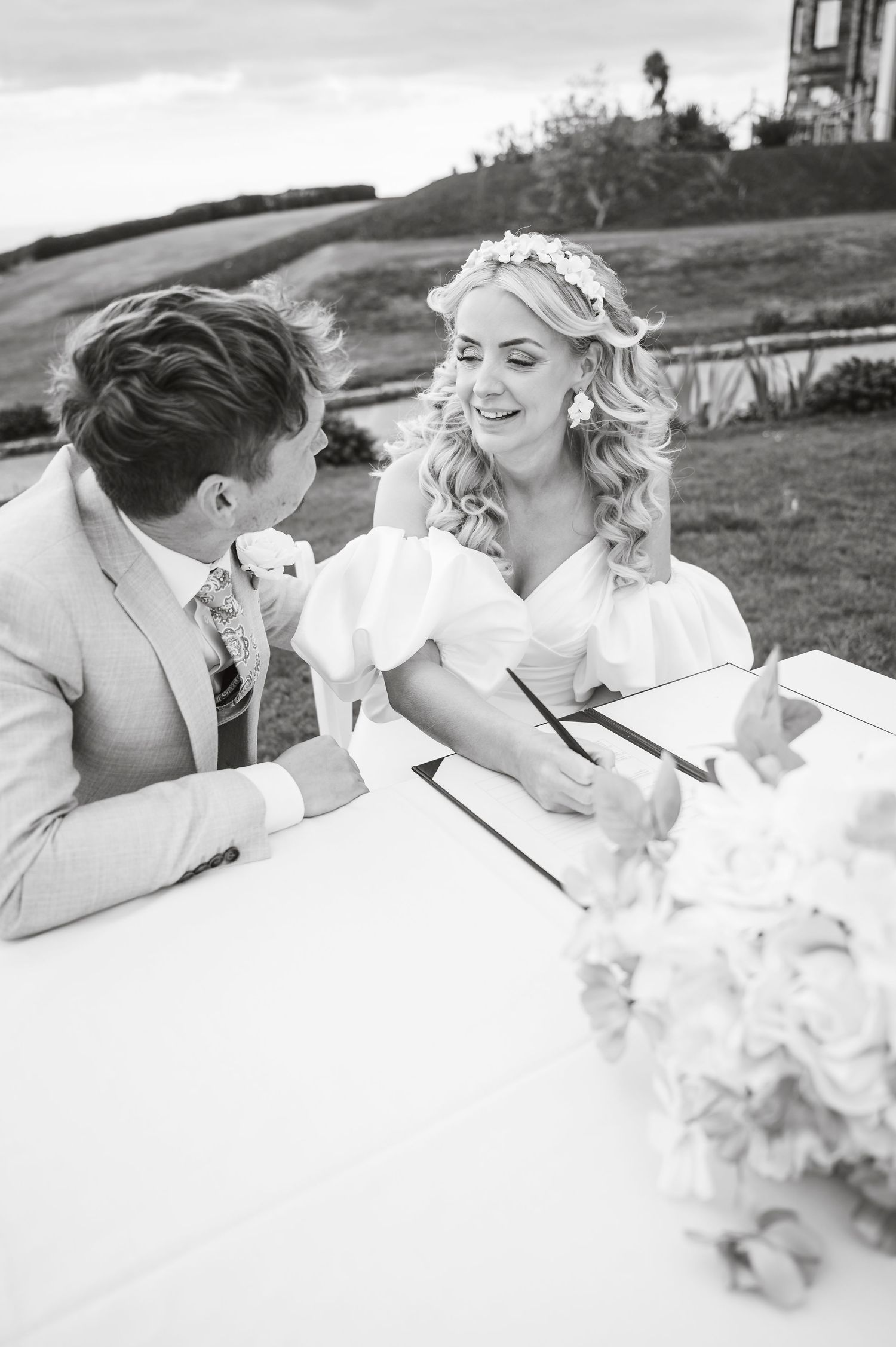 Black and white wedding photo collage showing romantic moments between newlyweds.