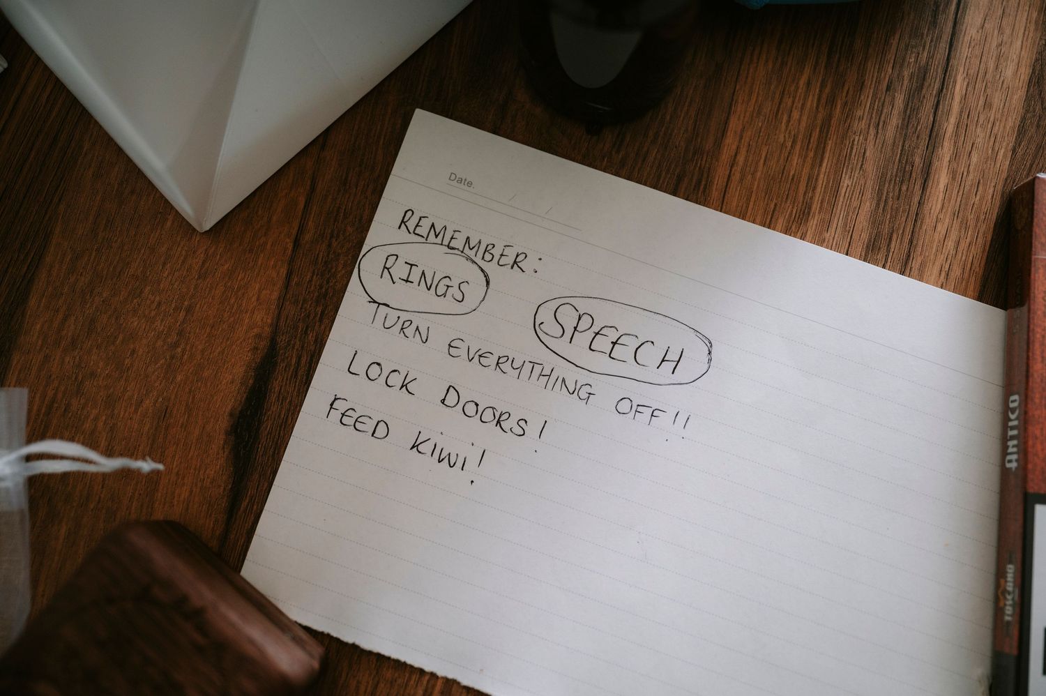 Wedding planning notes and speech details written in notebook.