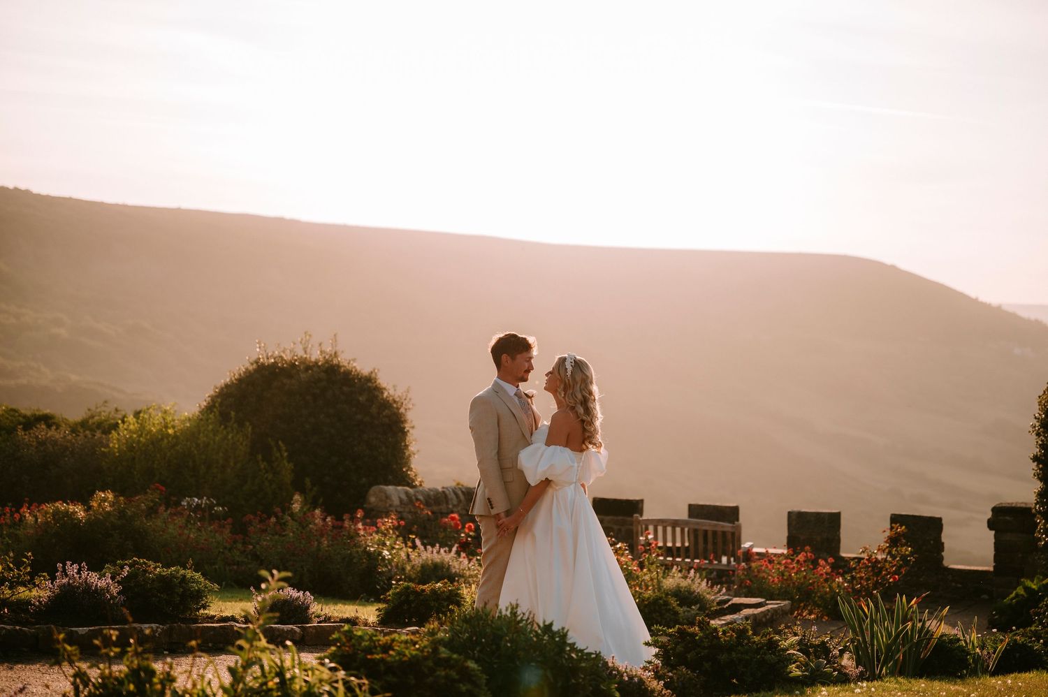 Romantic sunset moment in a hilltop garden with mountain views in the background.
