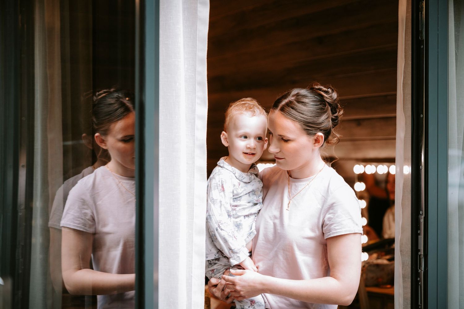 Wedding preparation scene in a cozy wooden cabin interior with natural lighting.