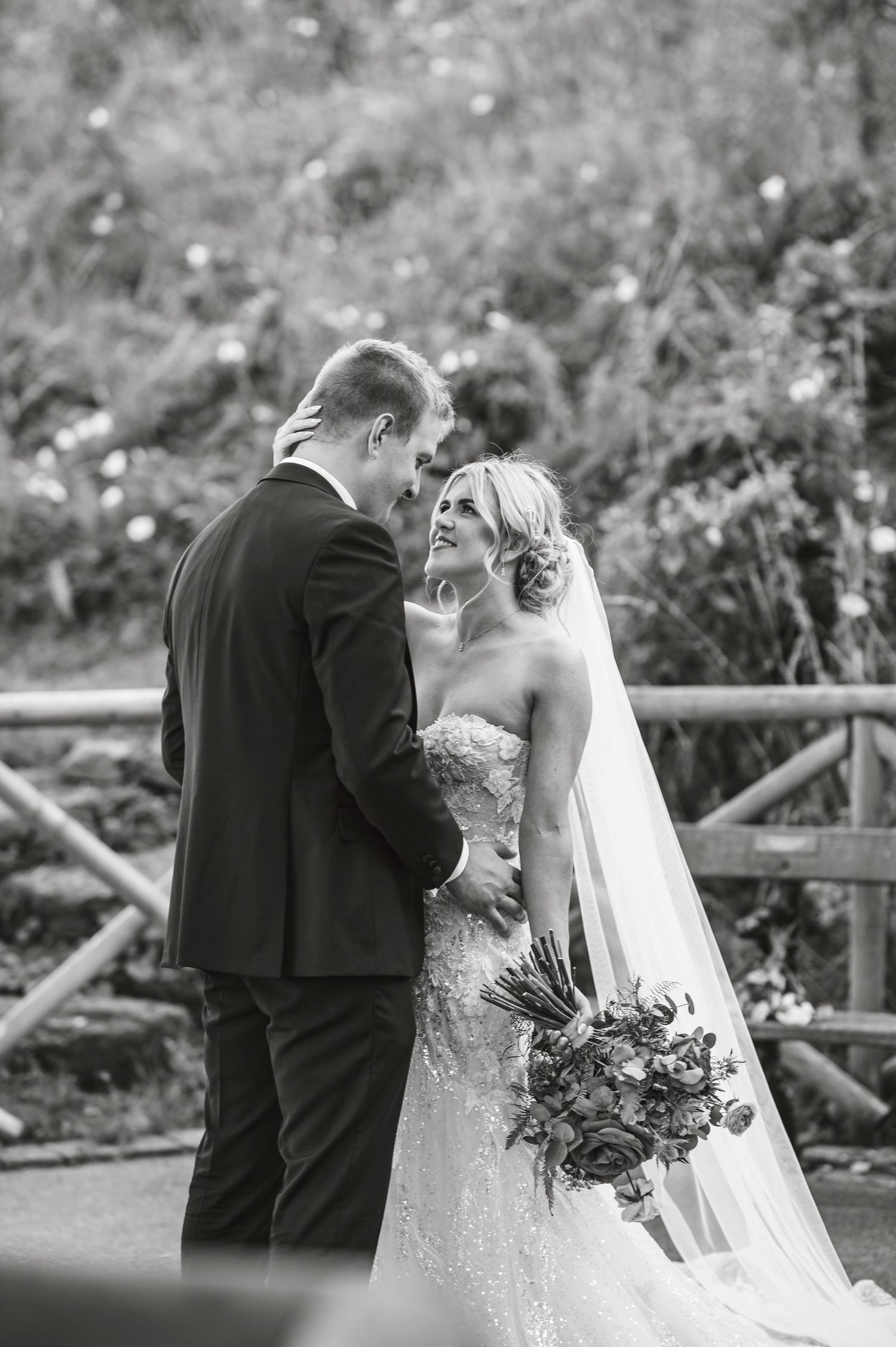 Romantic black and white wedding photos captured in a garden setting.