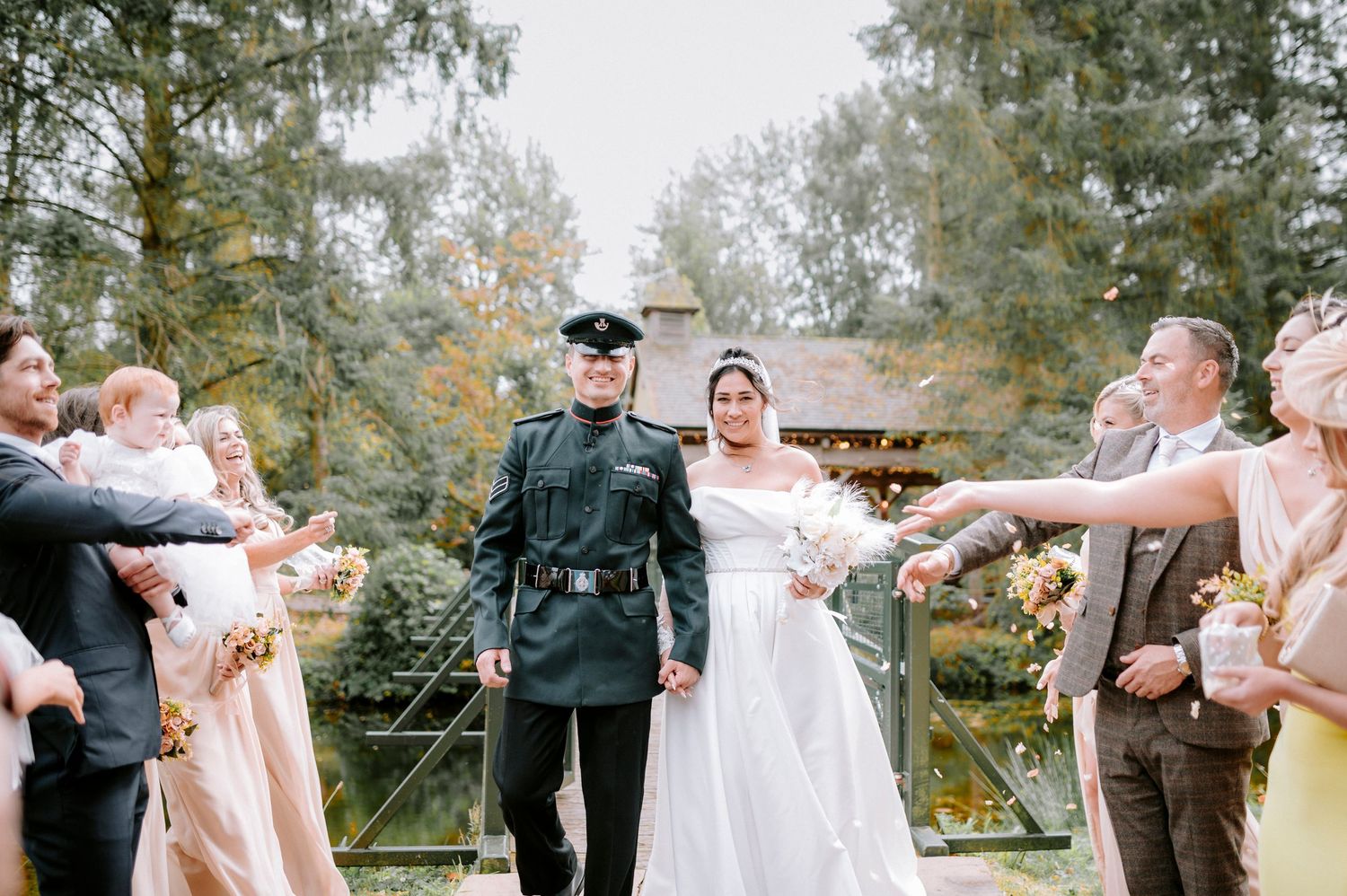 Wedding couple sharing a celebratory moment outdoors with guests.