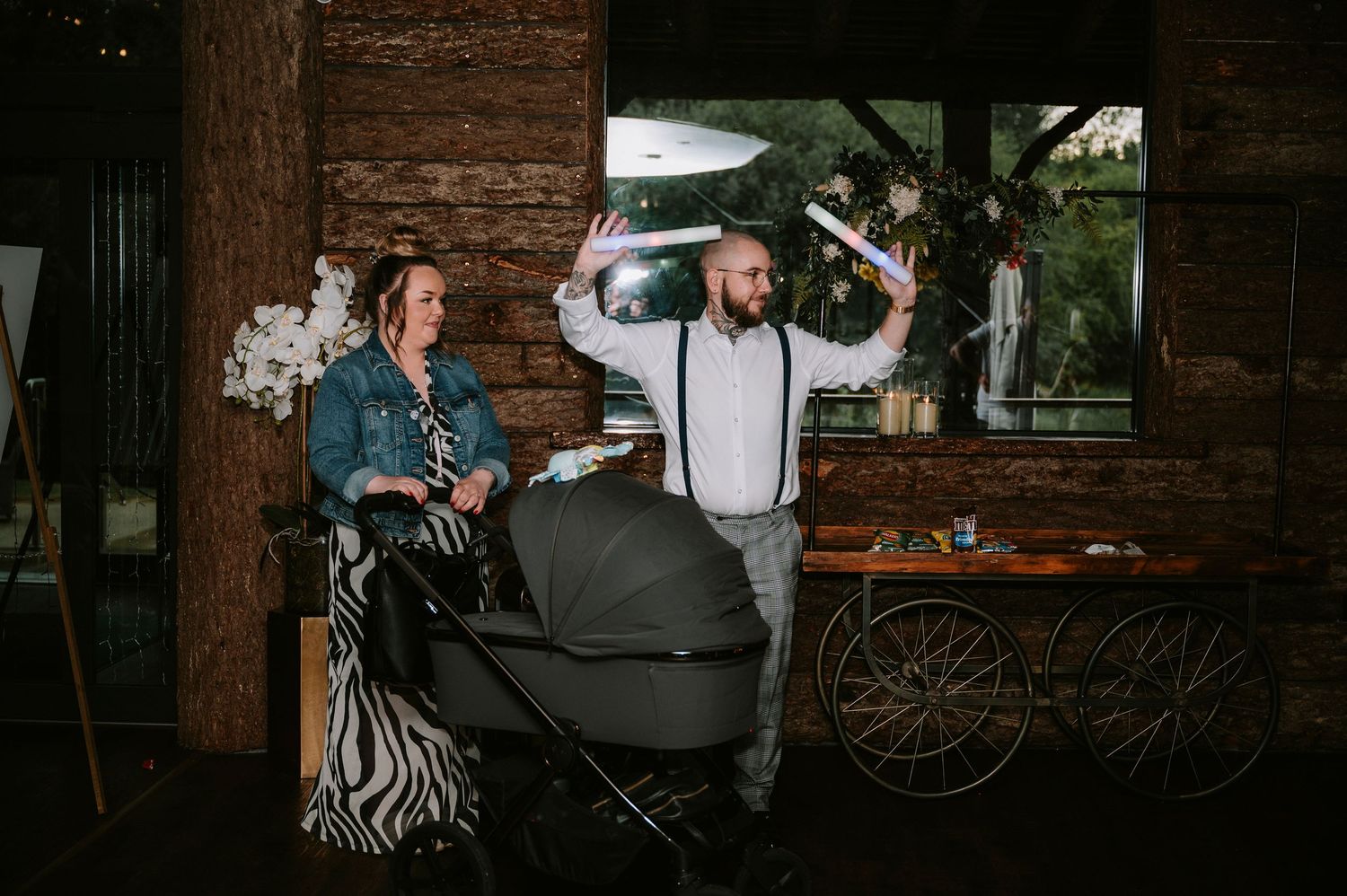 Wedding reception venue with rustic wood walls and ambient lighting.
