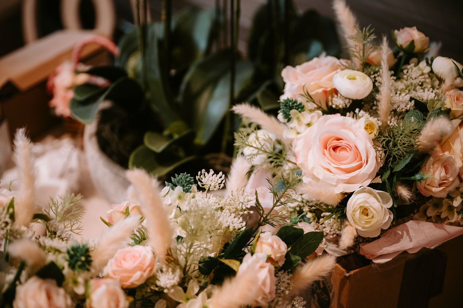 Soft pink roses and delicate flowers arranged in romantic wedding bouquet.