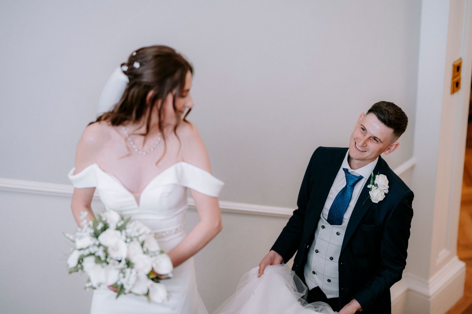 Wedding party members share candid moments during reception celebrations.