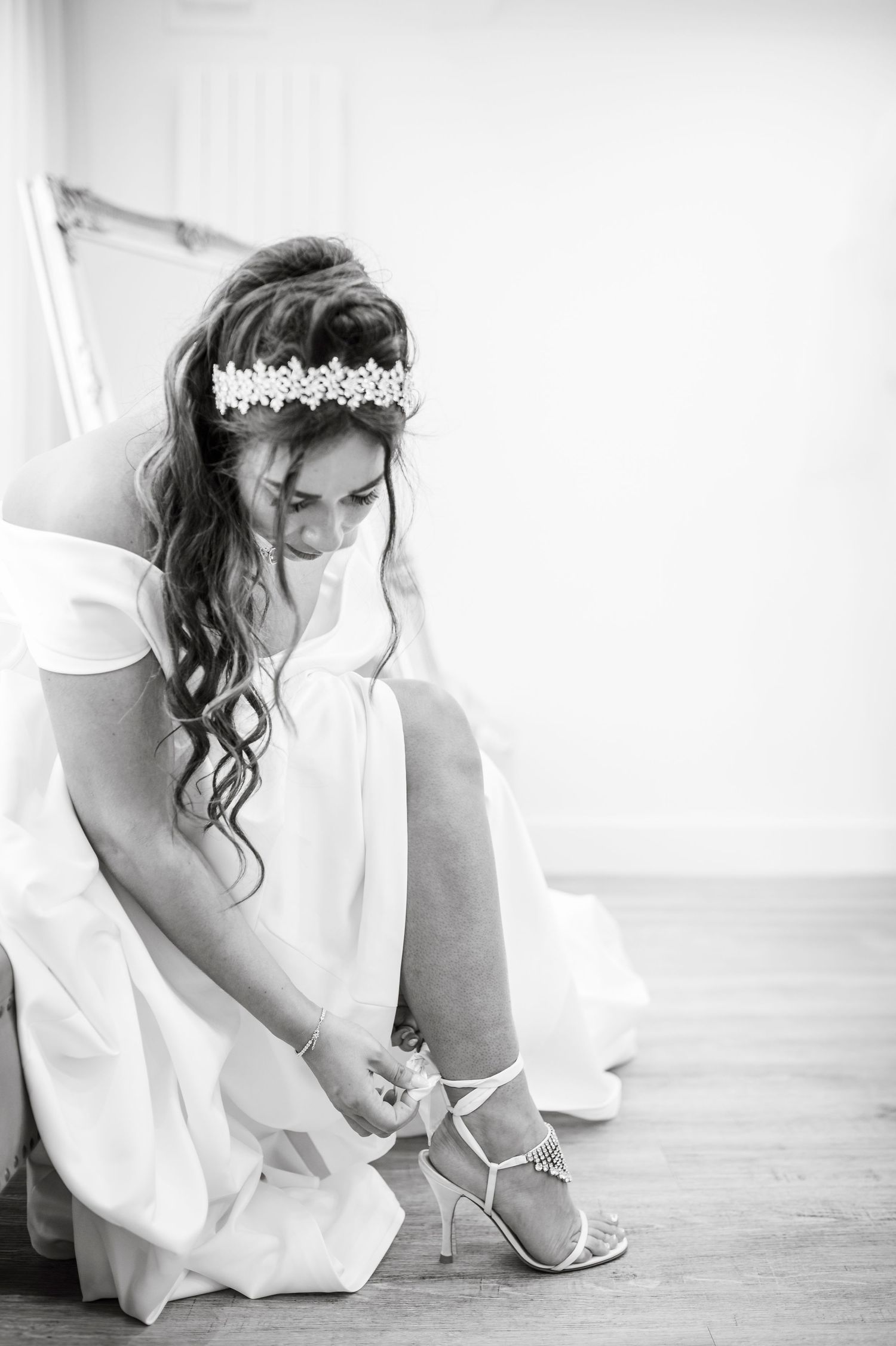 Bridal preparation moments captured in elegant black and white photography.