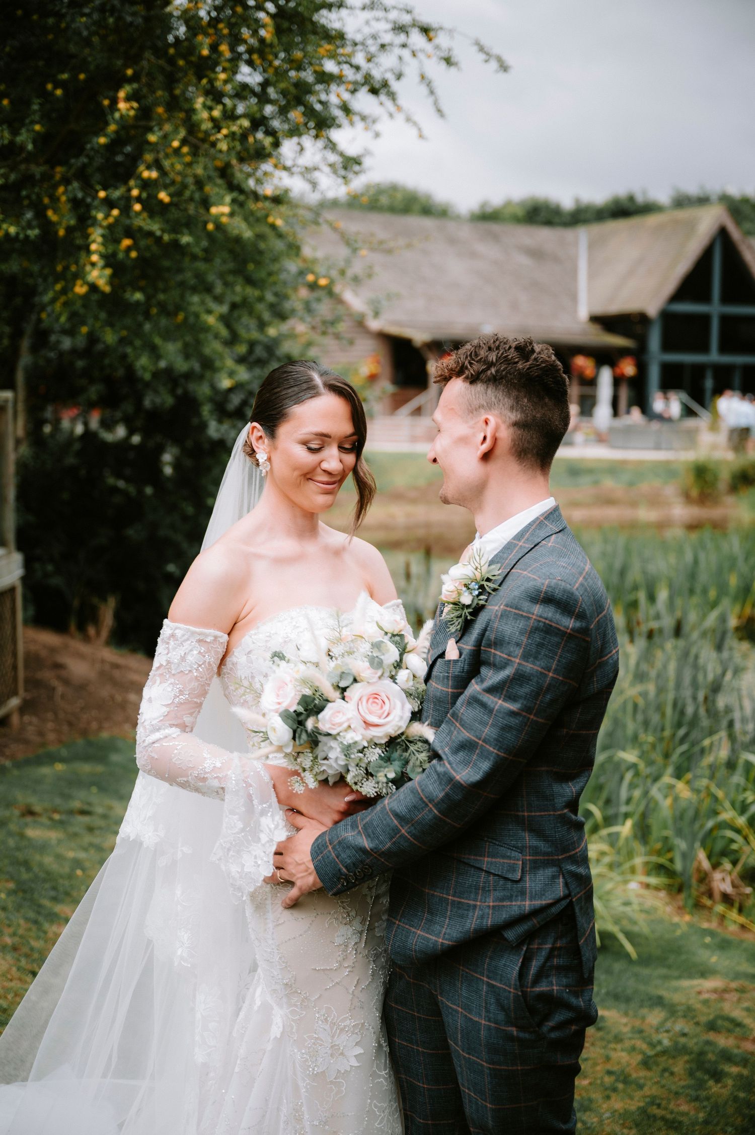 Romantic wedding portraits in a garden setting with lush greenery.