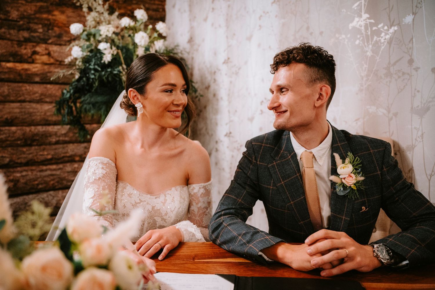 Newlyweds sharing an intimate moment at their rustic-themed wedding reception.