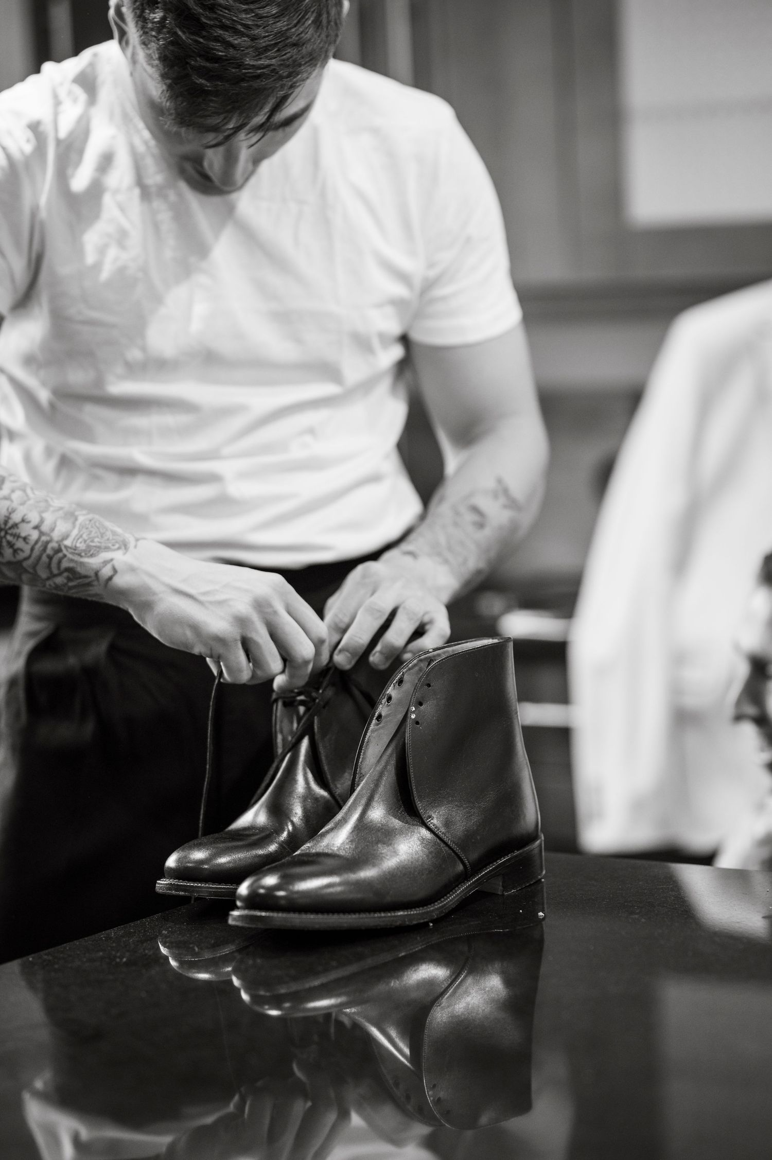 Person polishing formal black leather dress shoes in preparation for special event.
