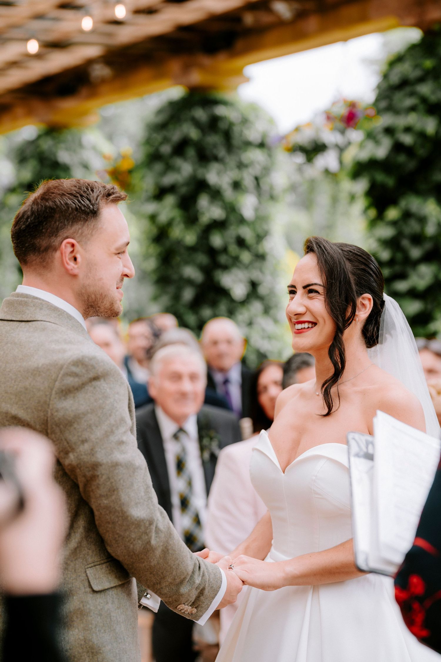 Couple shares emotional first dance moment at outdoor wedding reception.