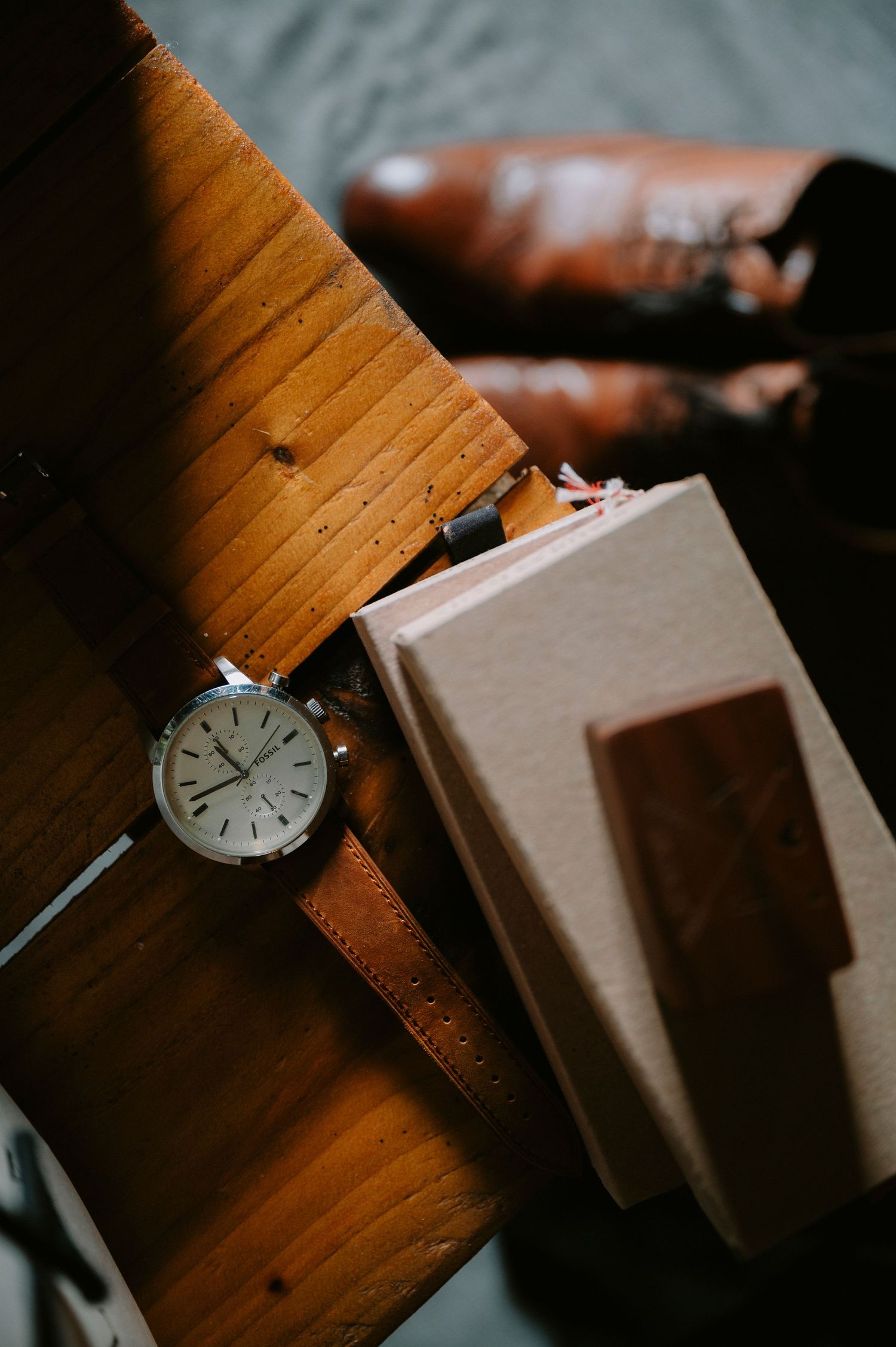Close-up of vintage wristwatch on wooden surface next to cardboard box.