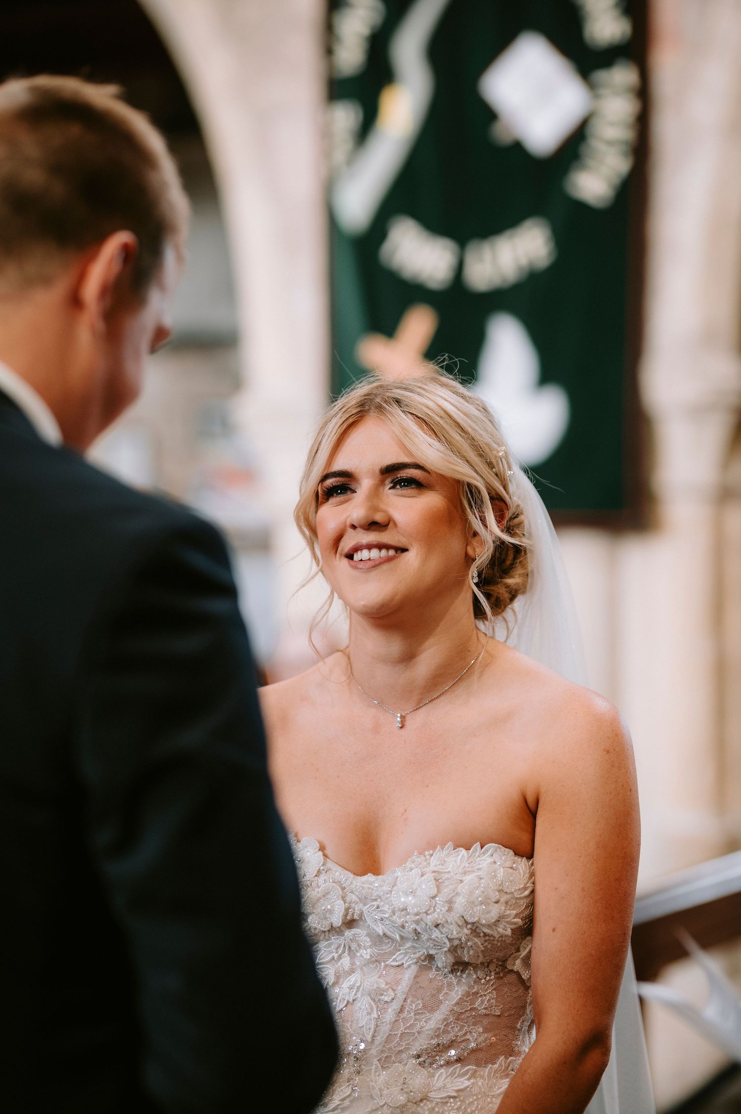Wedding ceremony moment showing joyful expressions in an ornate church setting.