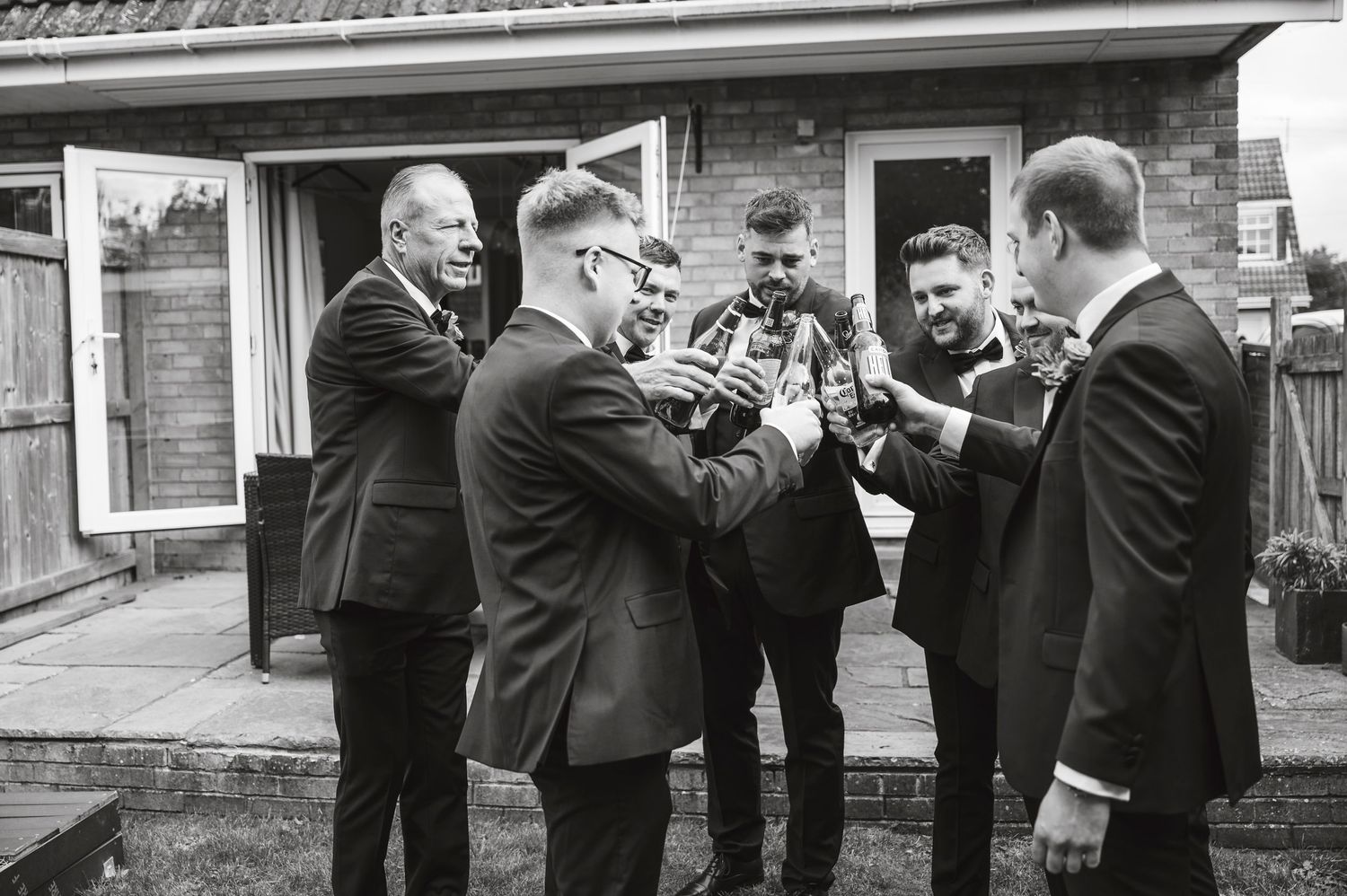 Candid moments of groomsmen getting ready in formal attire.