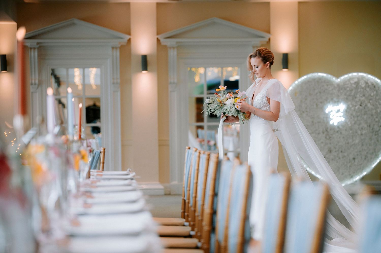 Wedding venue hallway with elegant columns and romantic lighting.