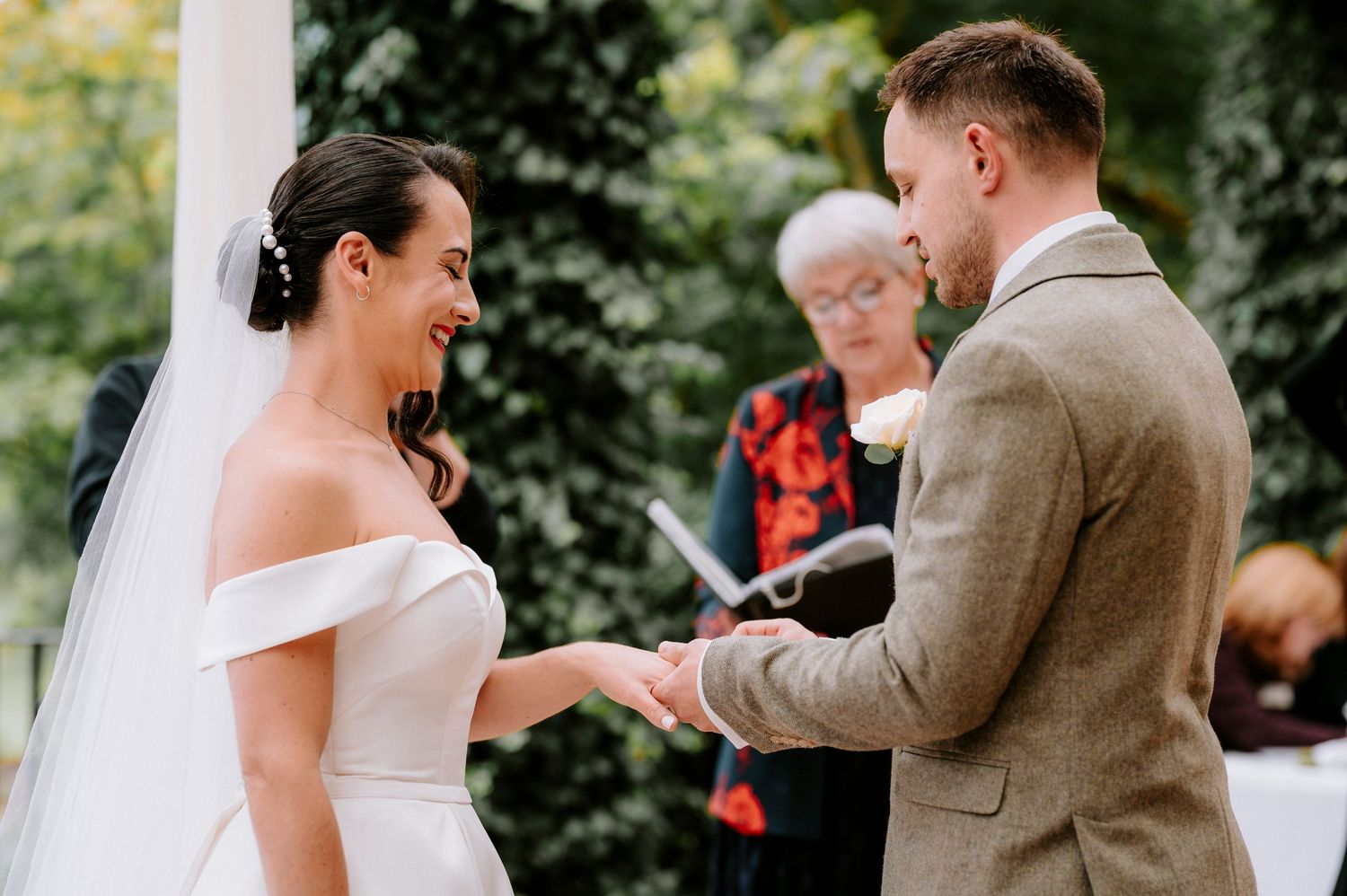 Couple exchanges vows during intimate garden wedding ceremony.