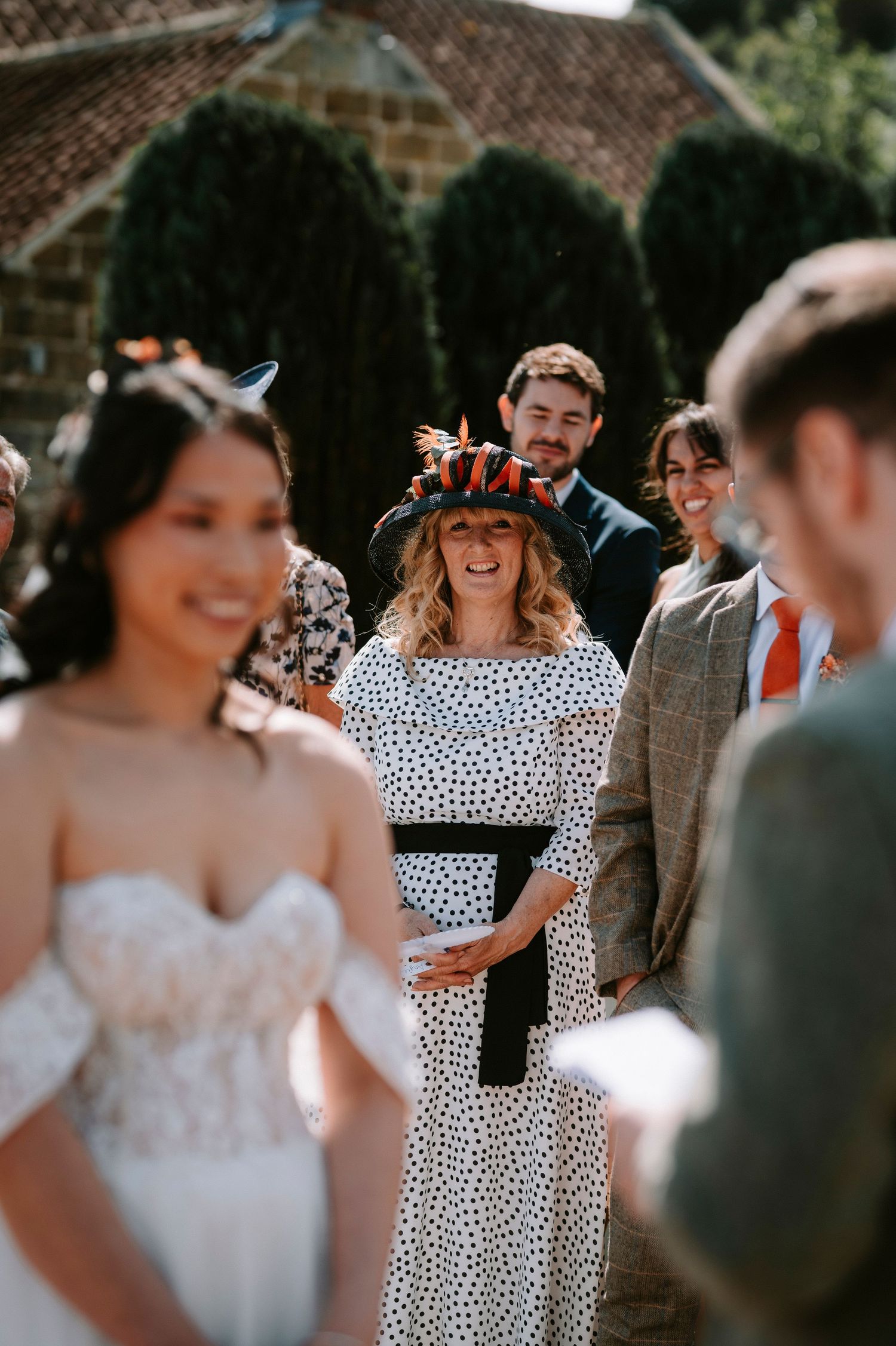 Wedding celebration with guests in polka dot dresses and formal attire.