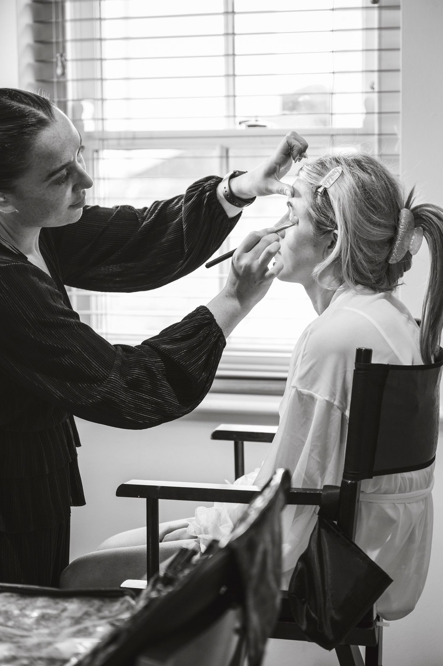 Black and white sequence of wedding day hair and makeup preparation.
