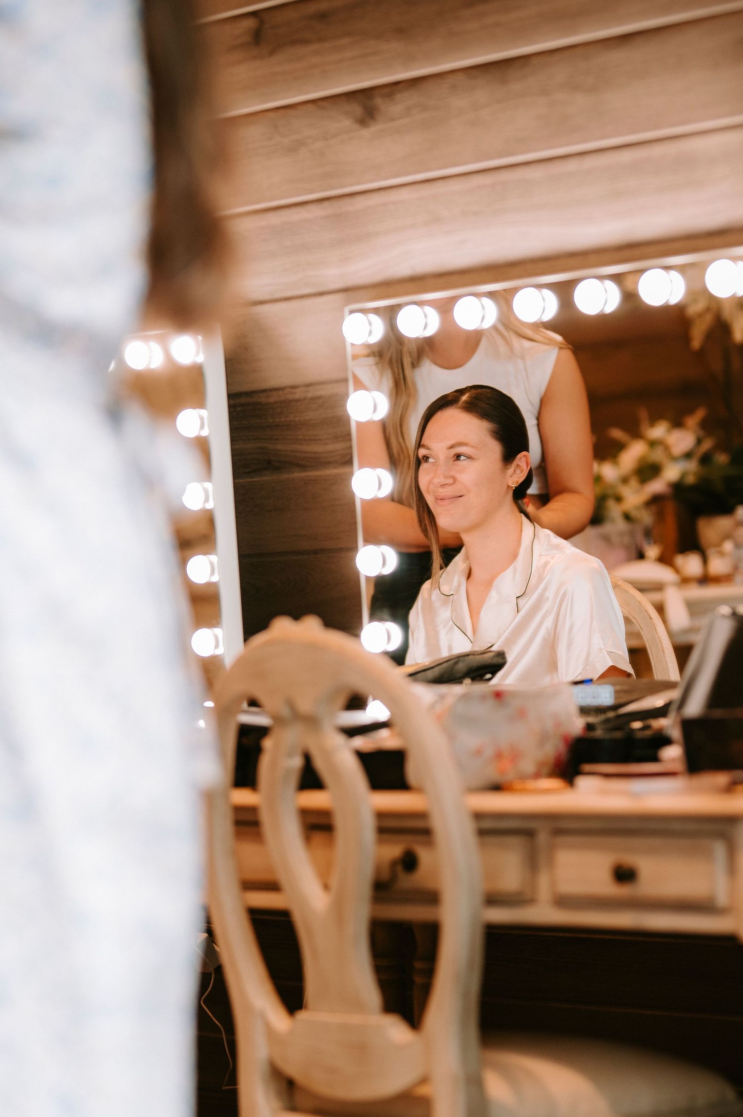 Behind the scenes preparation in a dressing room with vanity lights.