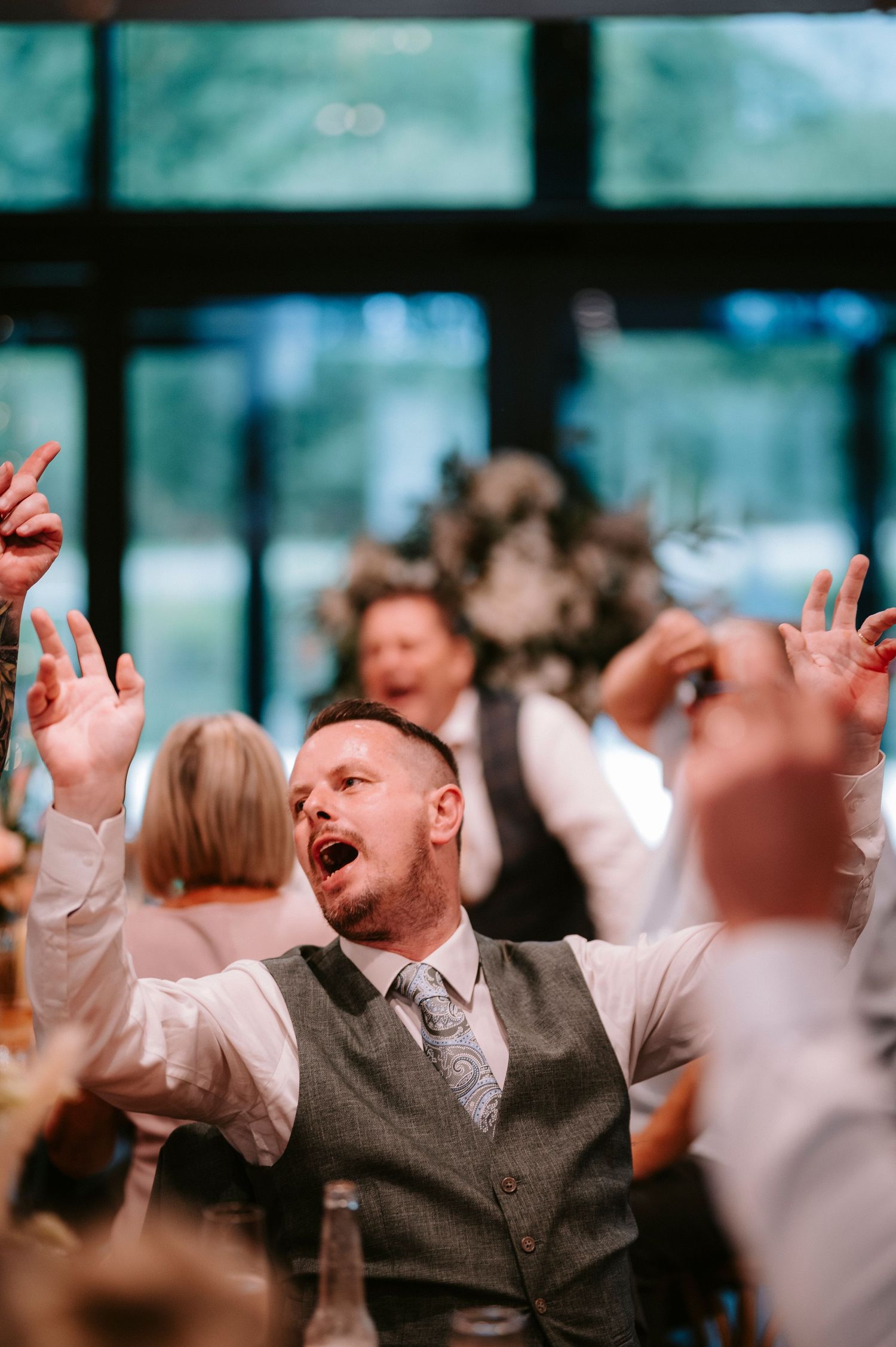 Wedding guests dancing and celebrating at a lively reception.