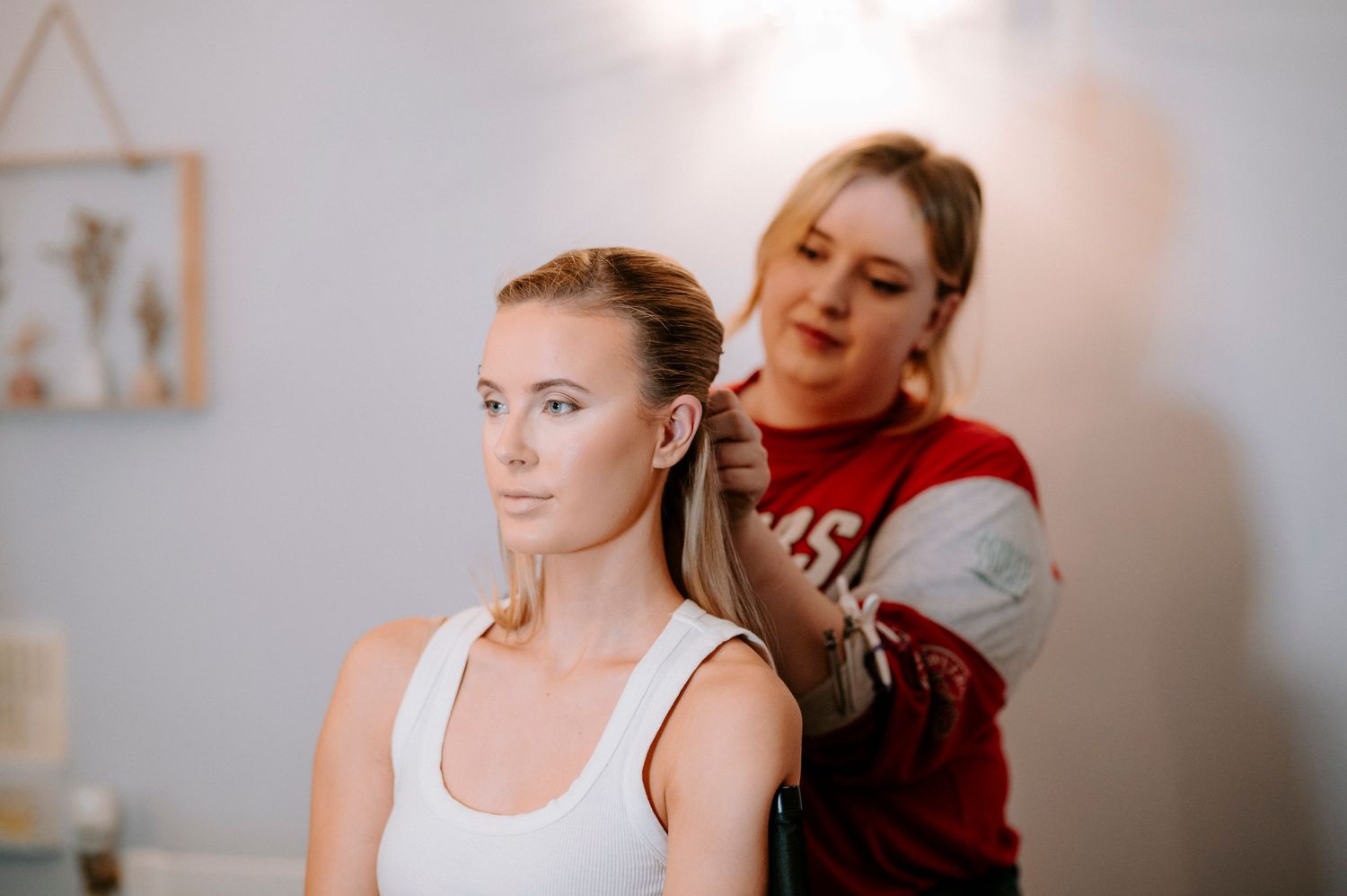 Professional makeup artist preparing for a beauty session in a bright studio.