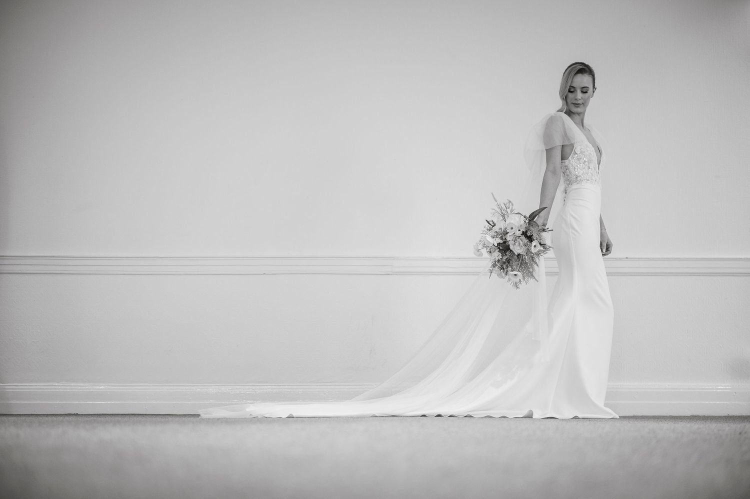Classic bridal portraits in black and white against a simple white backdrop.