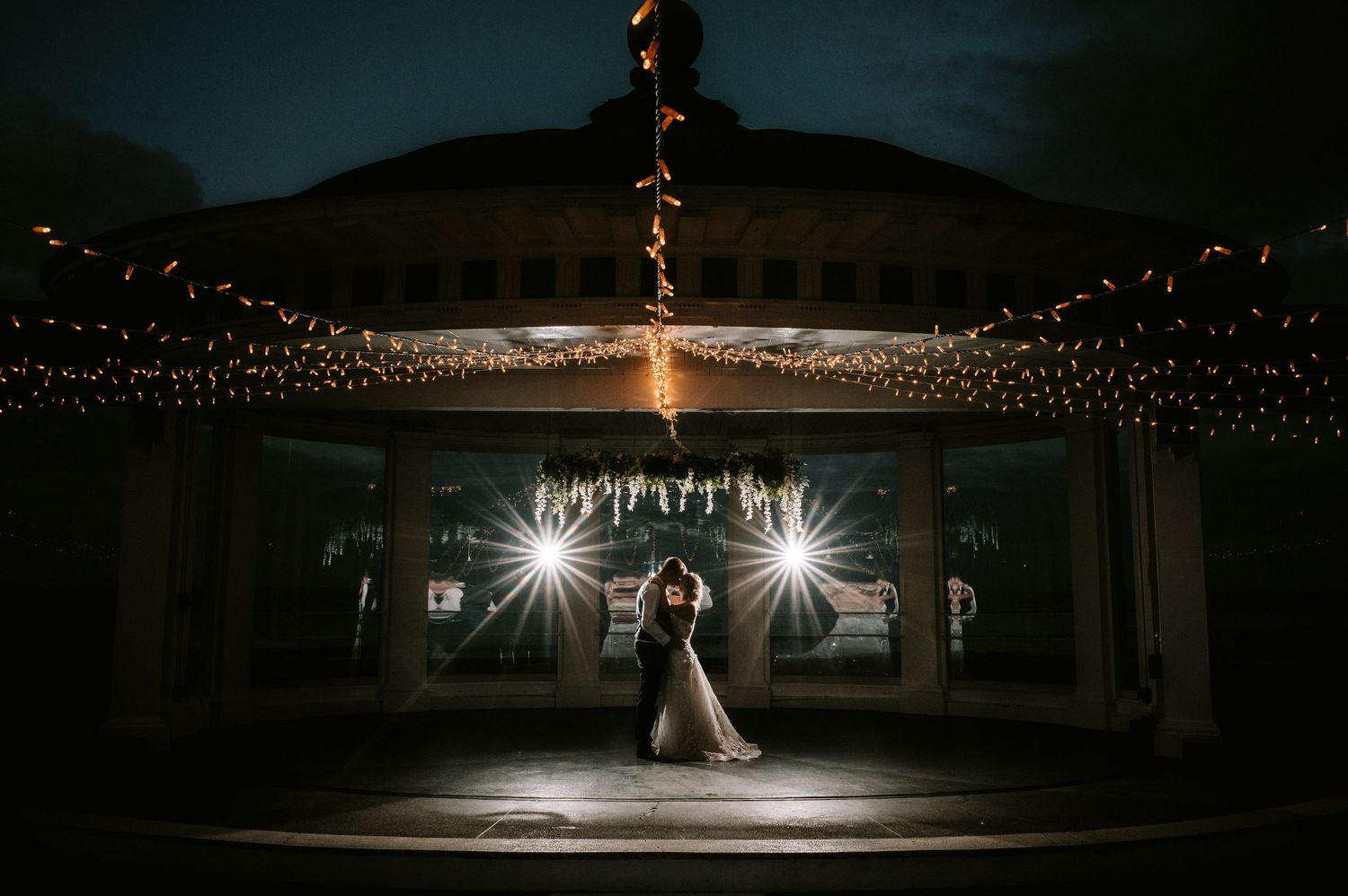 Wedding venue at dusk with twinkling lights creating a magical atmosphere.