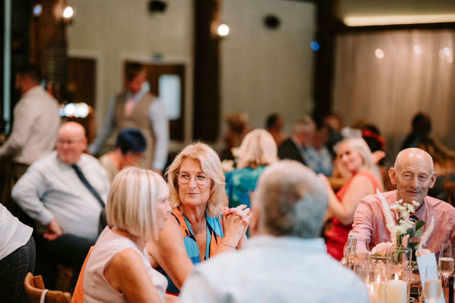 A collage of wedding reception scenes showing guests dining and socializing at elegantly decorated tables.