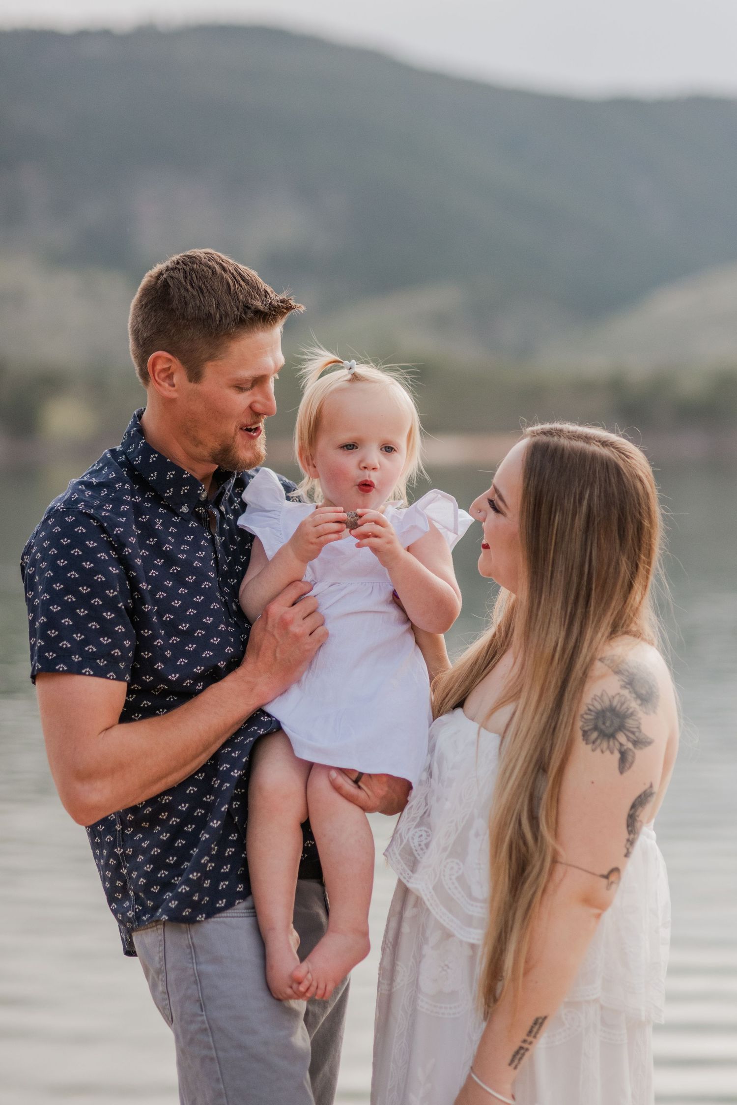 Dreamy beachy family photography session, with Father, Baby, and Mother looking on. Fort Collins CO