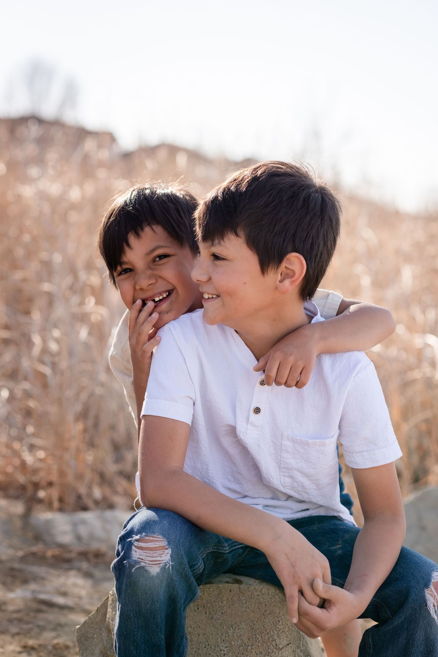 Family Photography brothers candid moment, beachy photo session at McIntosh Lake, Longmont, CO by Angelice Caballer