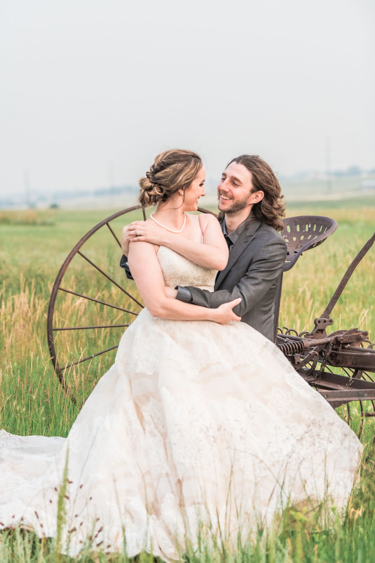Couples portrait, looking at each other, sitting in vintage farm, true to life style, Stillwater Ranch Venue photography  Angelice Caballer