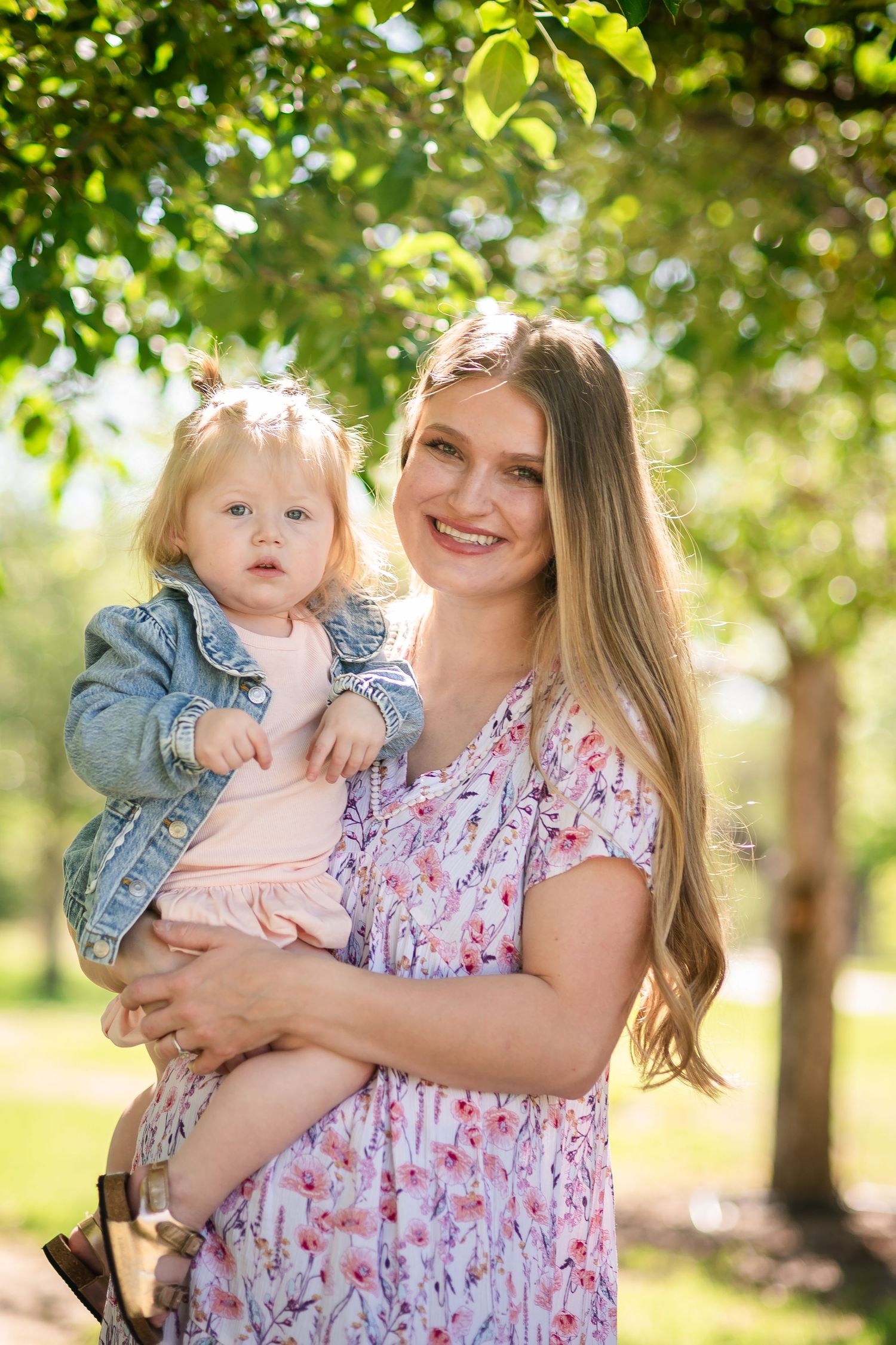 Family photography, Mother and daughter pose under an apple tree, true to life colors, spring at Rogers Grove, Longmont by Angelice Caballer