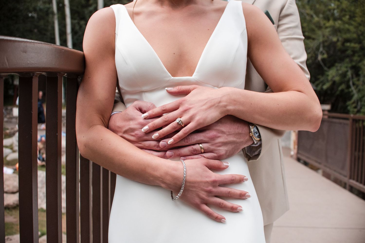 Couples portraits touching rings at the Vail Village Co., Mountain wedding. True-to-life, bright, and airy  photographer Angelice Cababller