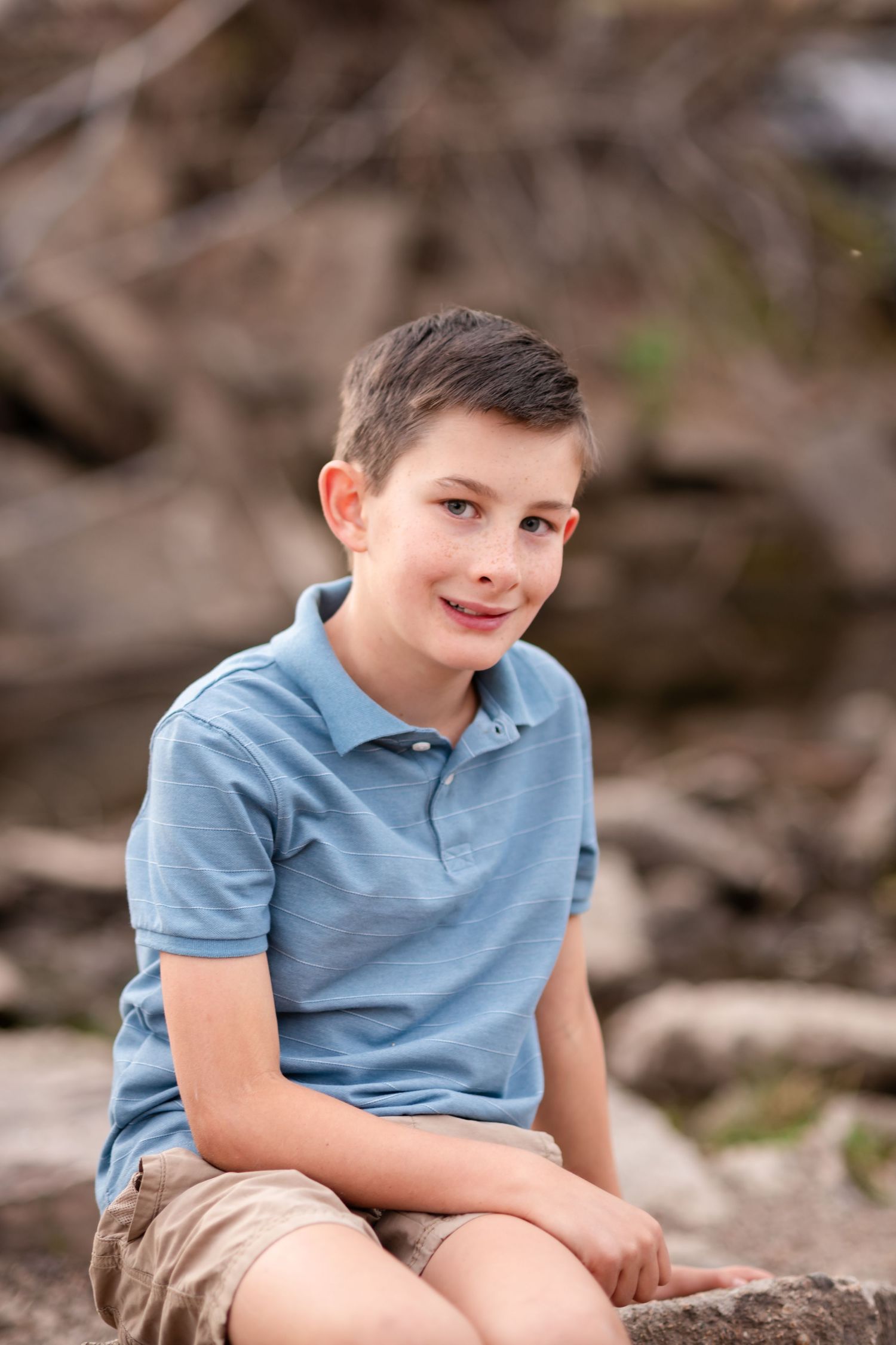 Family photography, playful ideas, child pose at waterfall, Golden Ponds, Longmont, CO, photography true-to-life by Angelice Caballler