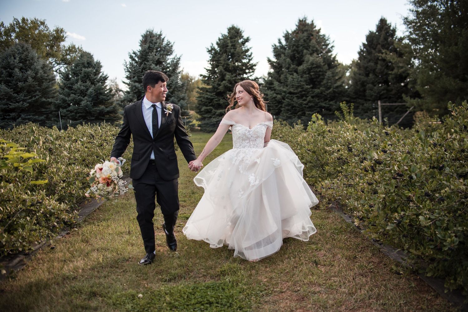Vineyard inspiration wedding ideas, a couple running in the vineyards for candid photos, Hillside Vineyard Event Center, Angelice Caballer