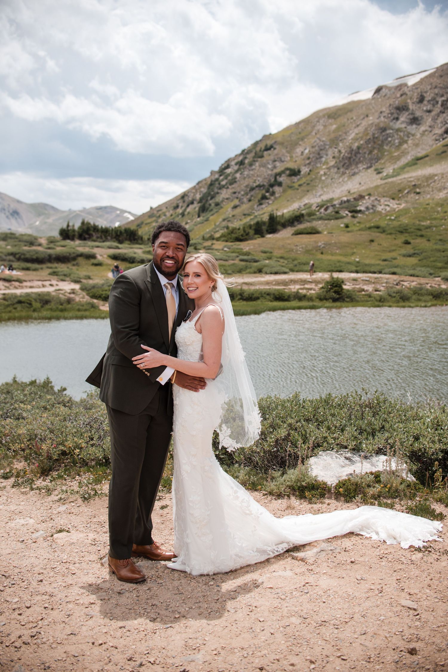 The wedding couple poses for formals, mountain wedding ideas at Loveland ski area resort, photography by Angelice Caballer