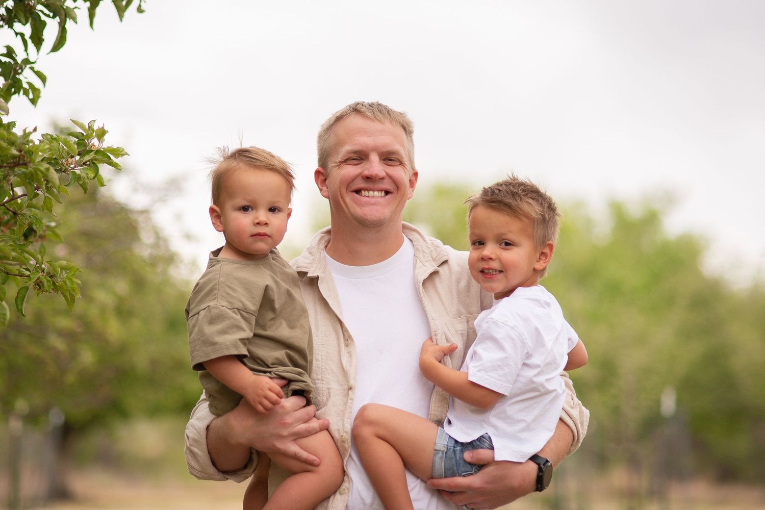 Family photography, Father and sons pose idea, true to life colors, spring  apple orchard at Rogers Grove, Longmont, by Angelice Caballer